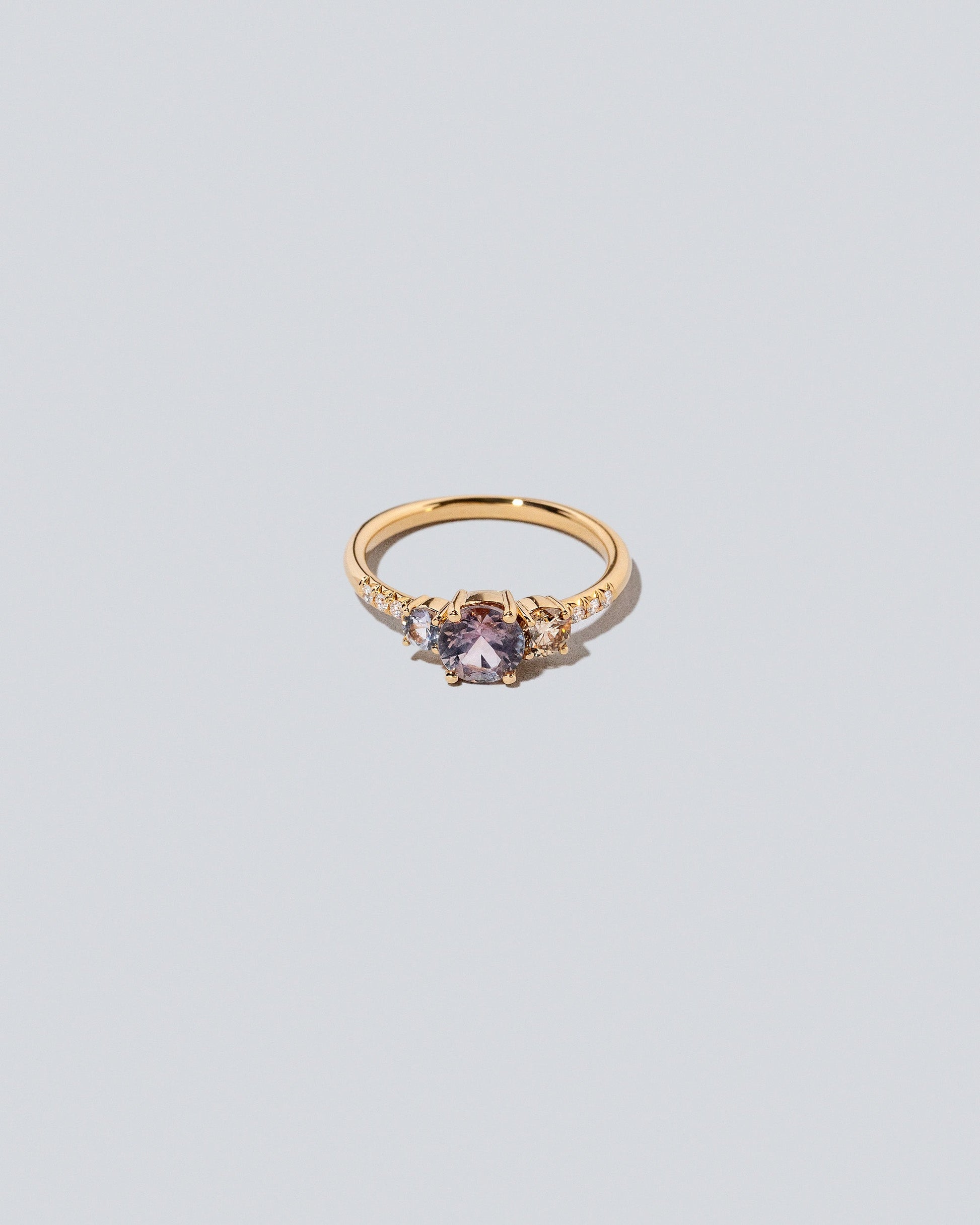 Purple Sapphire & Champagne Diamond Orion Ring on light color background.