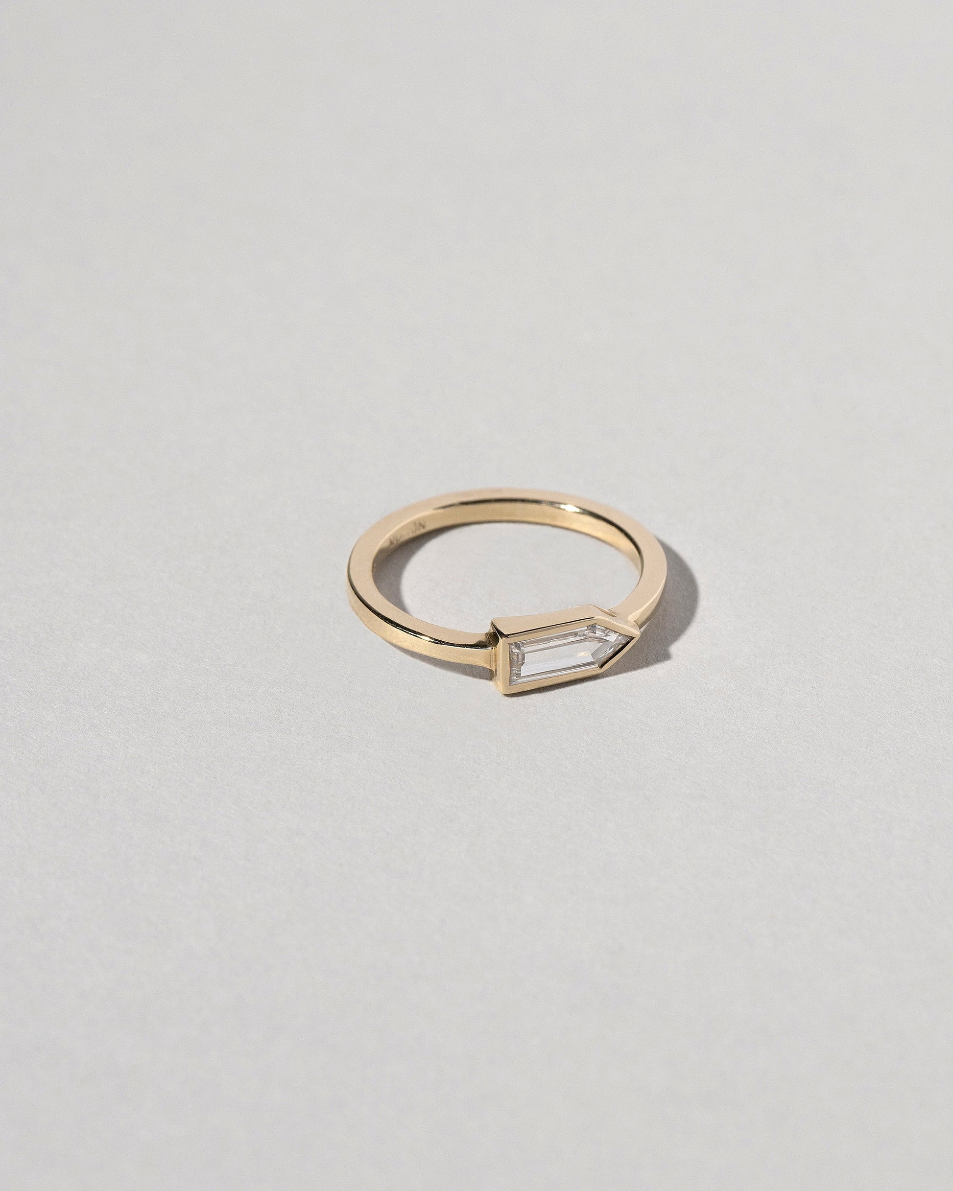 View from the side of the Bullet Cut Diamond Ring on light color background.