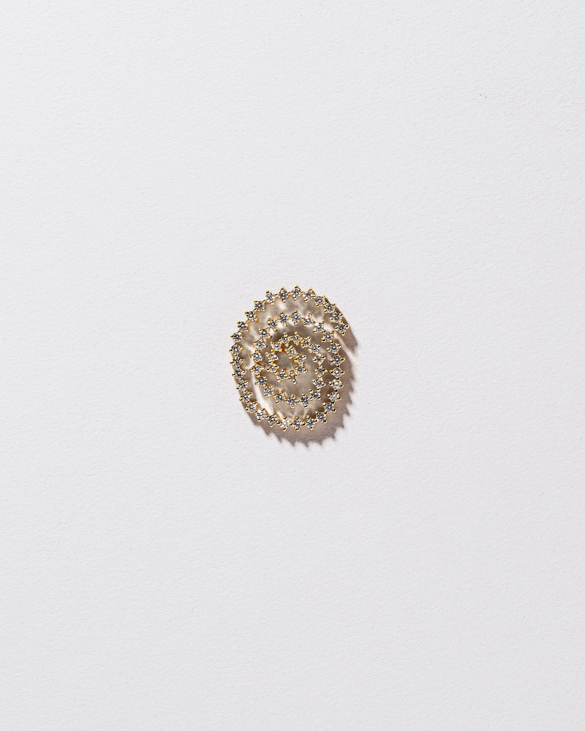 Right White Diamond Cycle of Rebirth Earring Single on light color background.