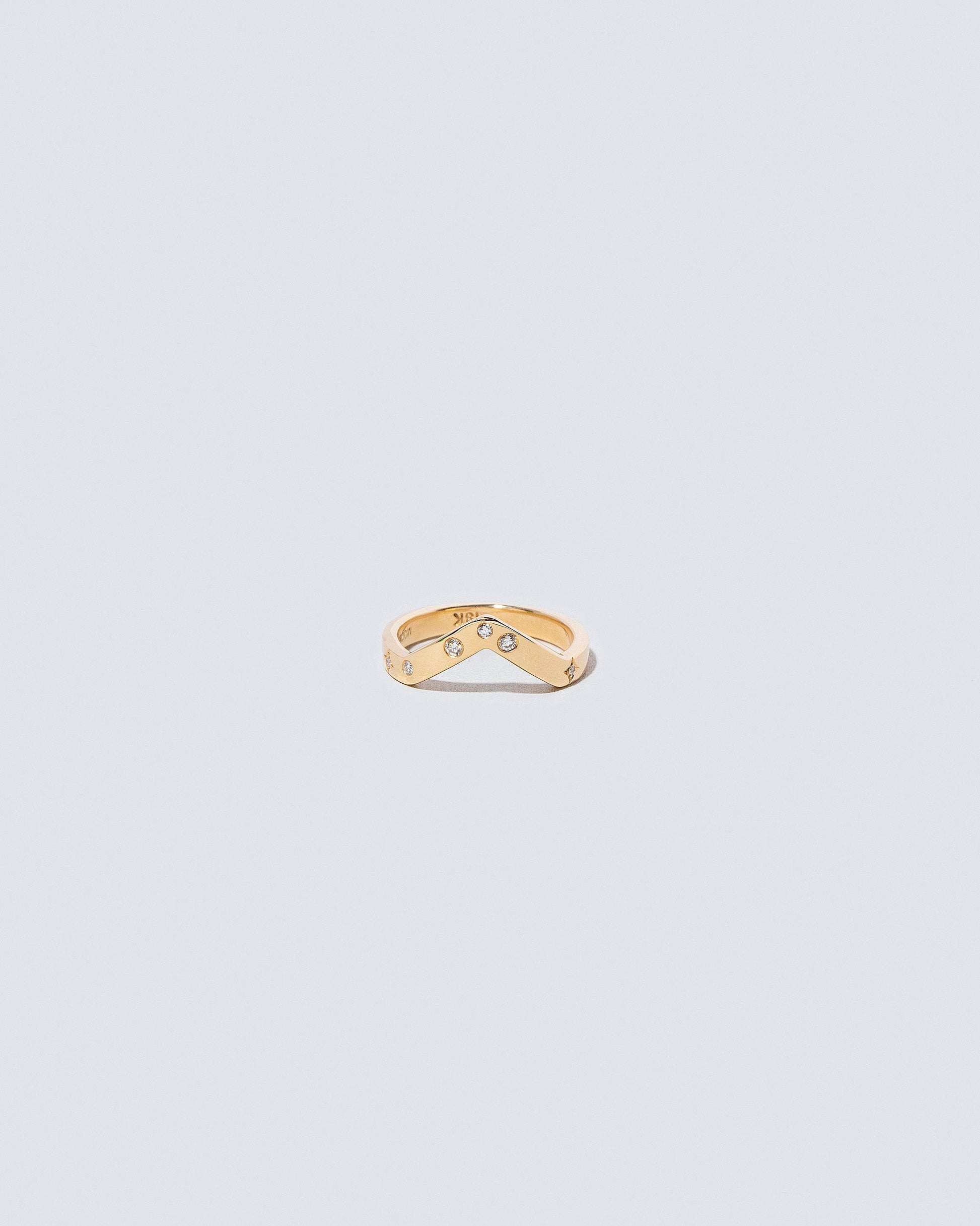 Gold Wide High Peak Band with white diamond little array added on light color background.