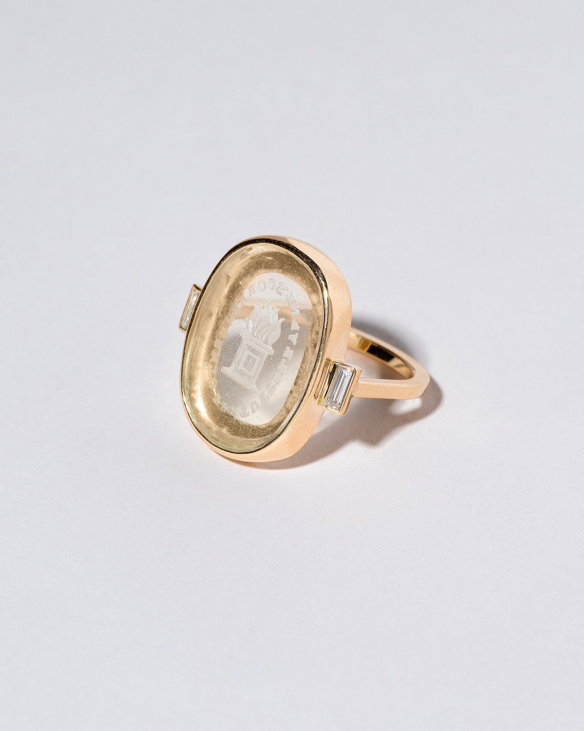 View from the side of the Passion Intaglio Seal Ring on light color background.