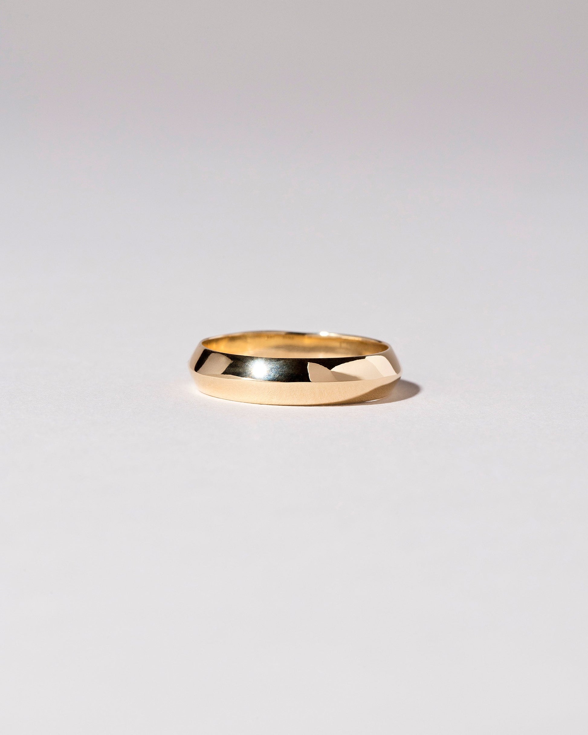 Gold 5mm Knife Edge Band on light color background.
