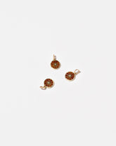 Orange Slice Charms on light color background.