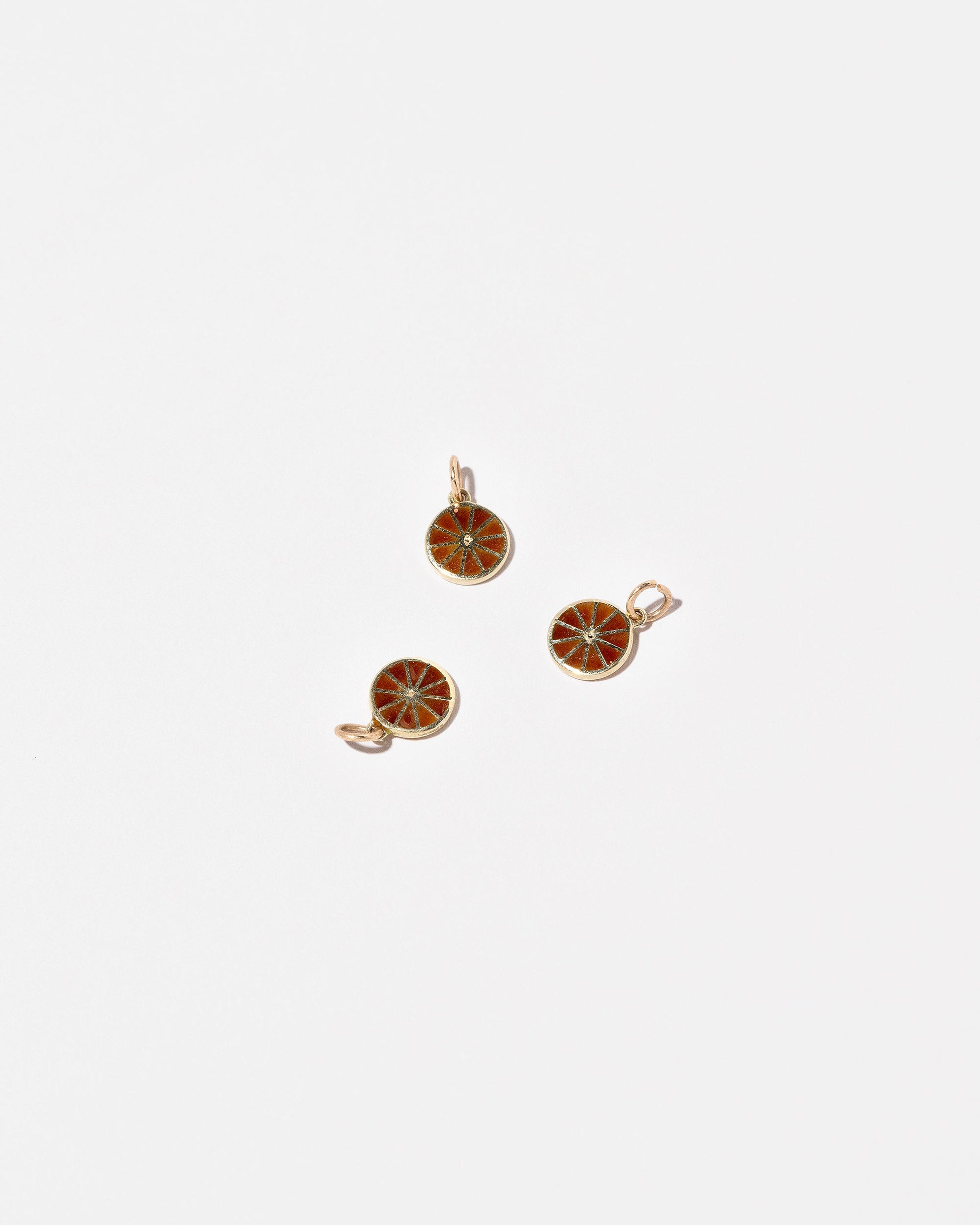 Orange Slice Charms on light color background.