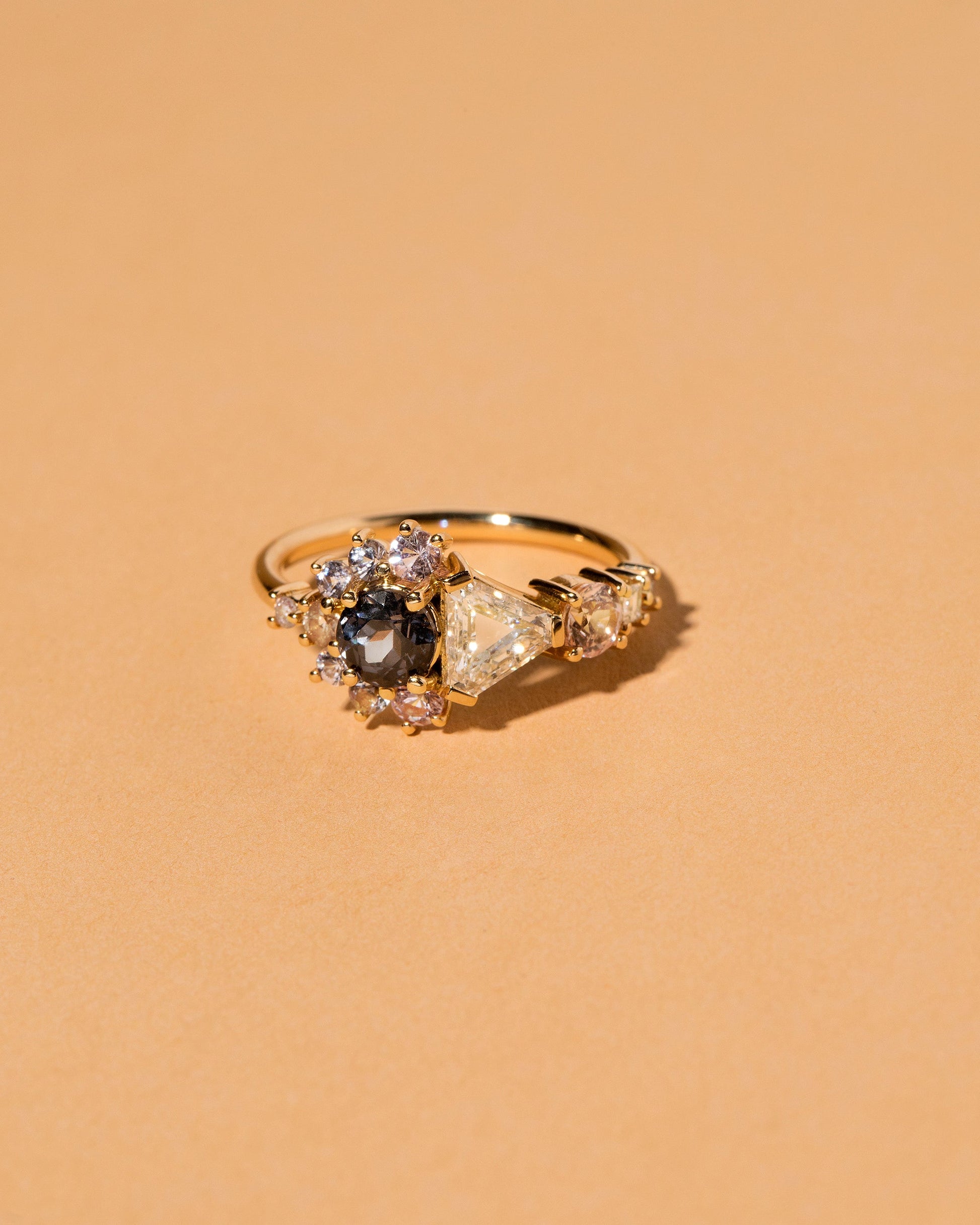  Diamond, Spinel & Sapphire Cluster Ring on light color background.