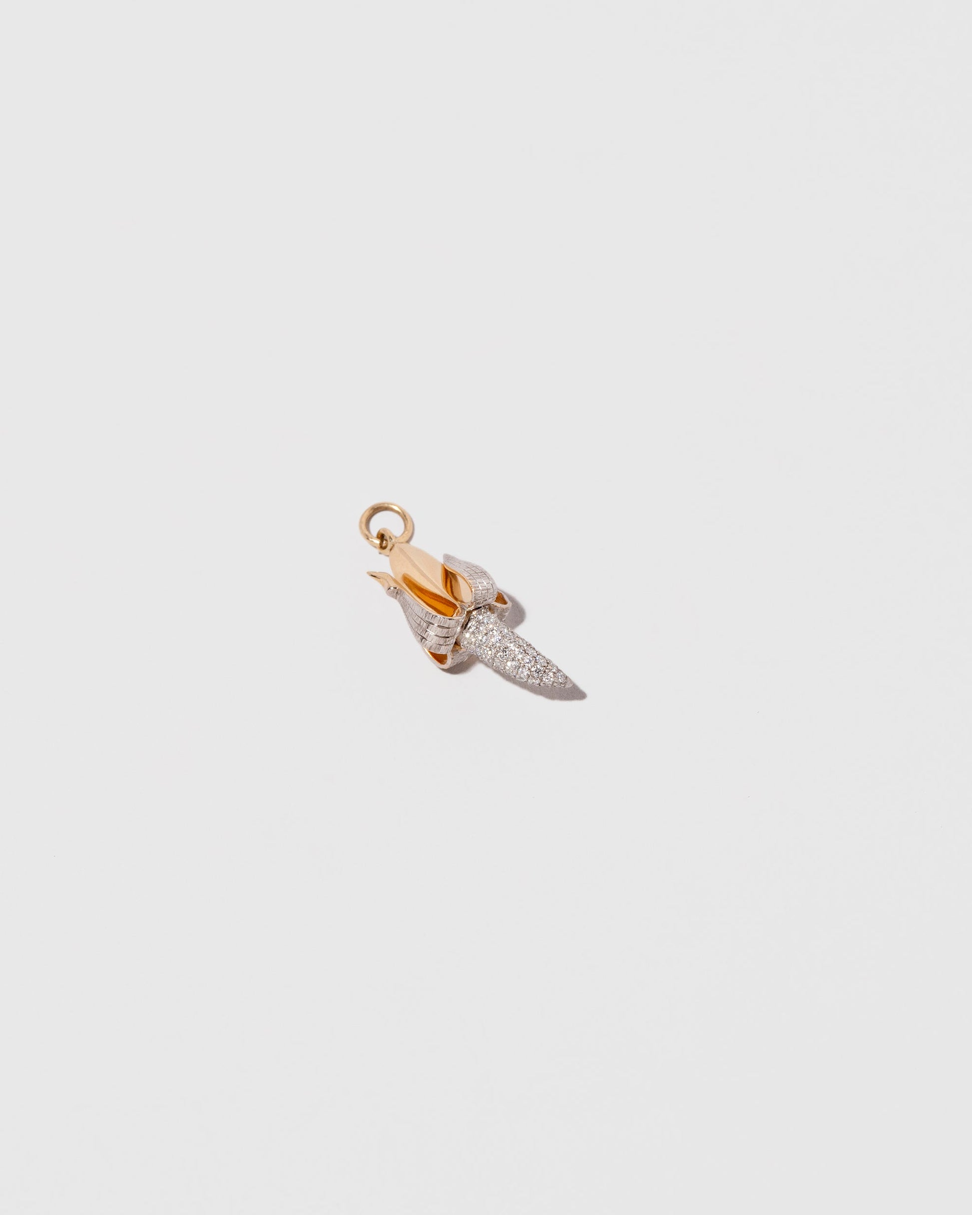 View from the side of the Peeled Banana Charm on light color background.