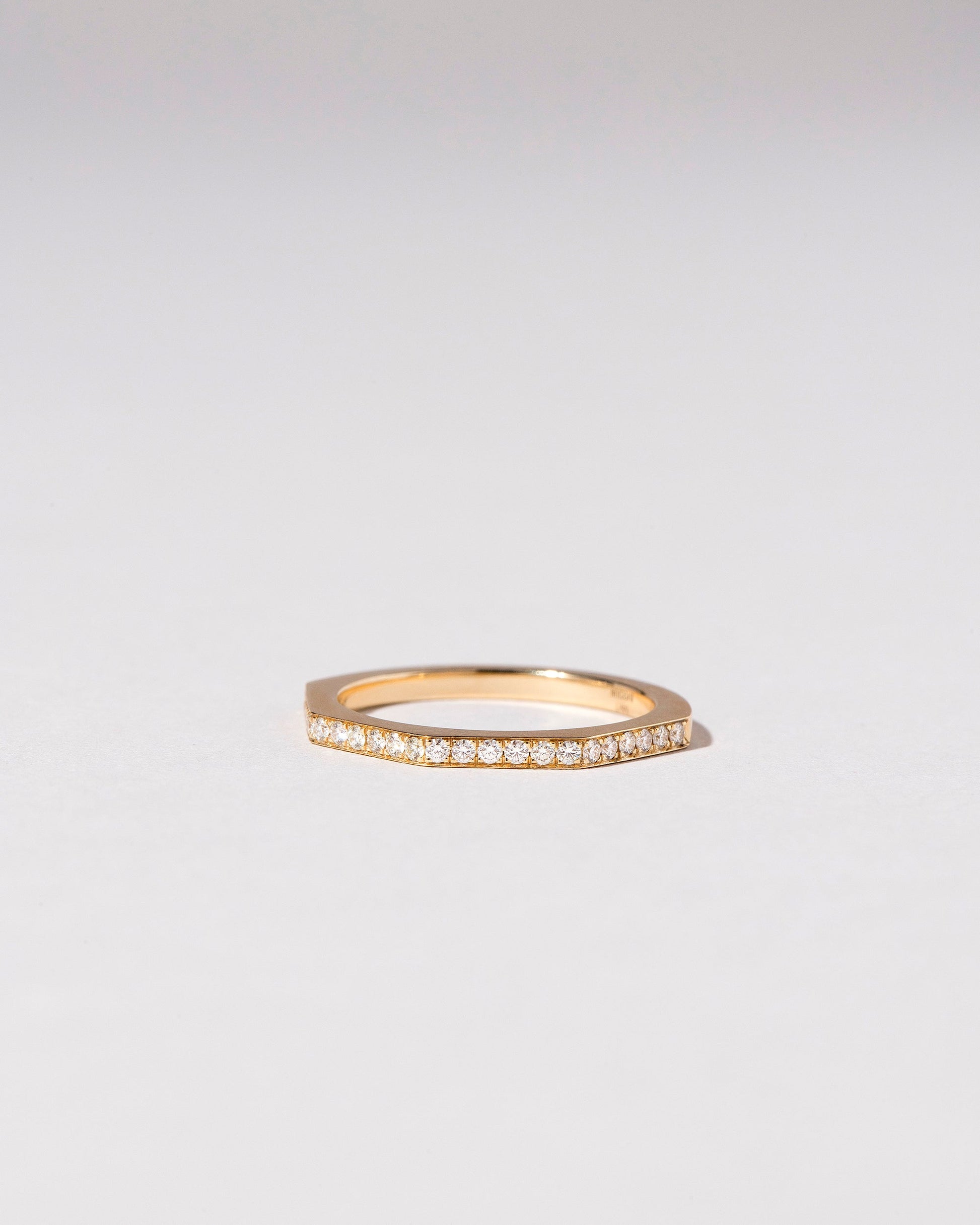 Gold Pavé 1.7mm Segmented Half Hoop Band on light color background.