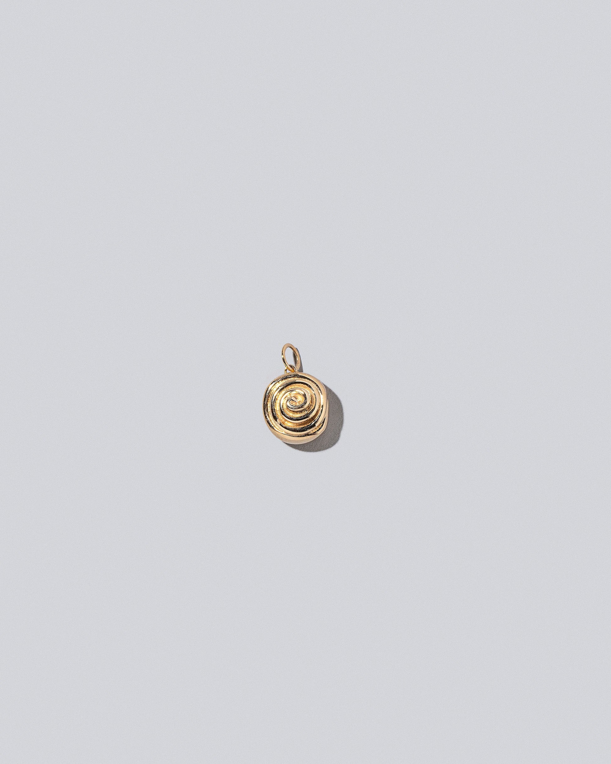 Cinnamon Roll Charms on light color background.