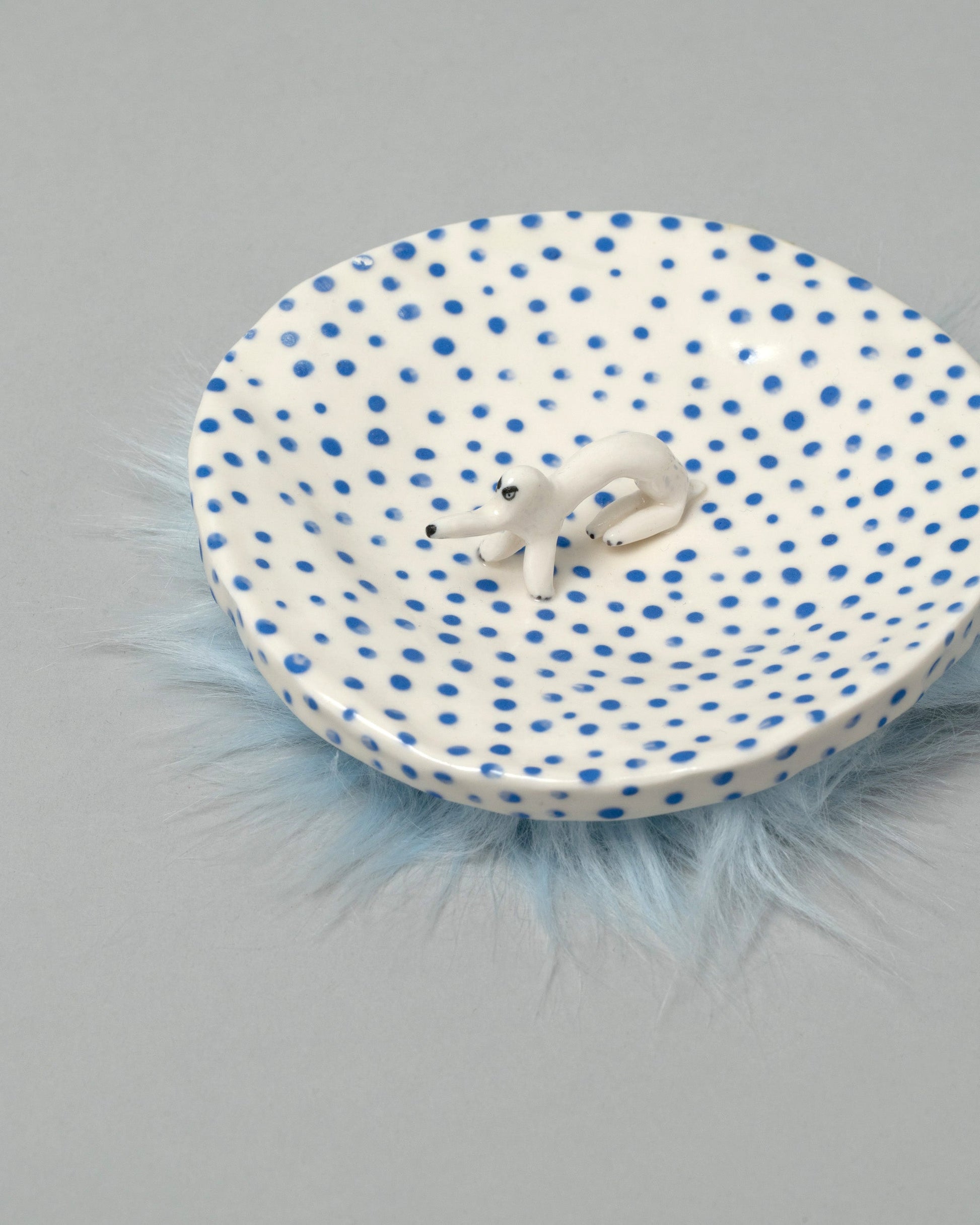Closeup detail of the Eleonor Boström Furry Dog Plate on light color background.
