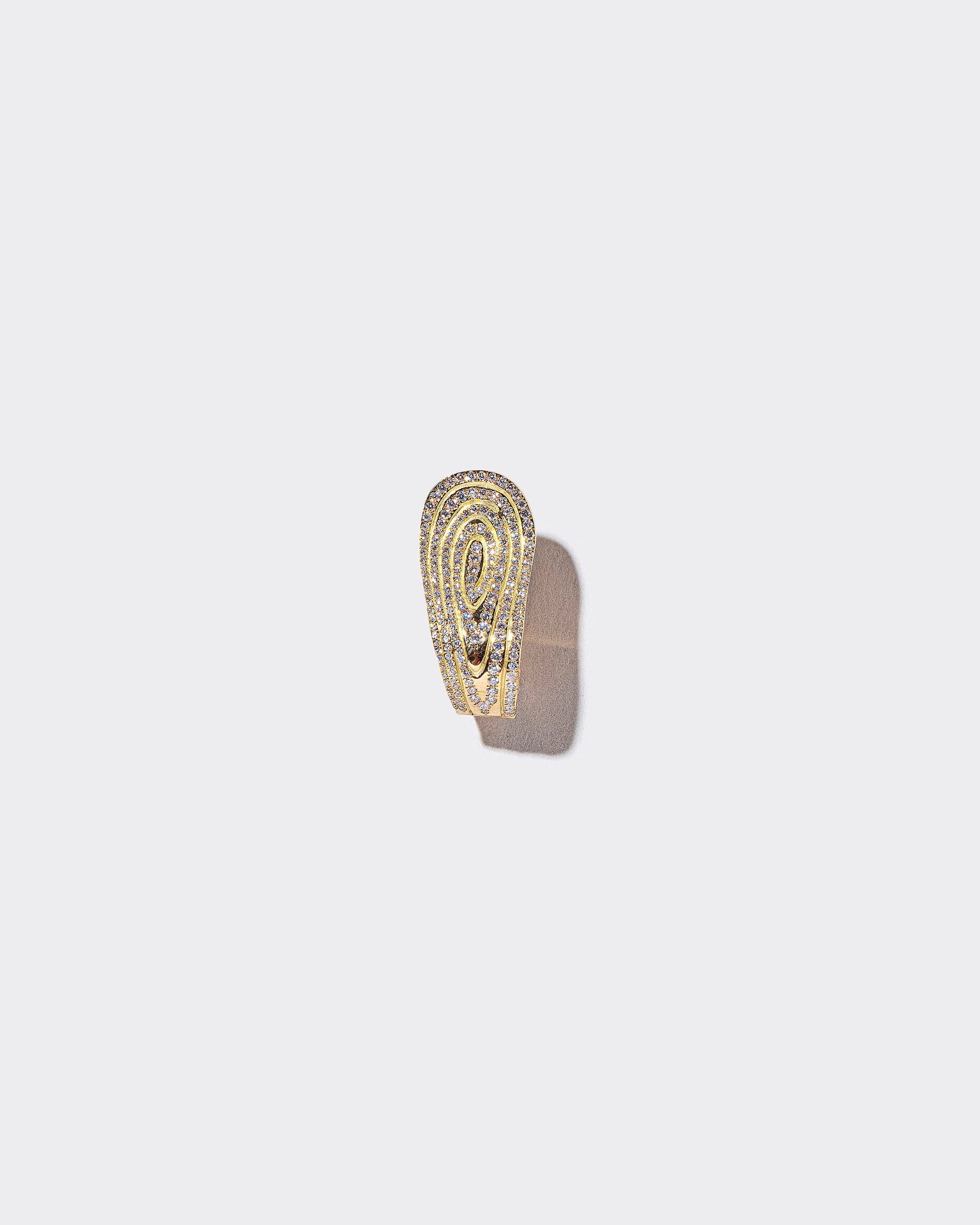 White Diamond Duality Hoop Earring on light color background.