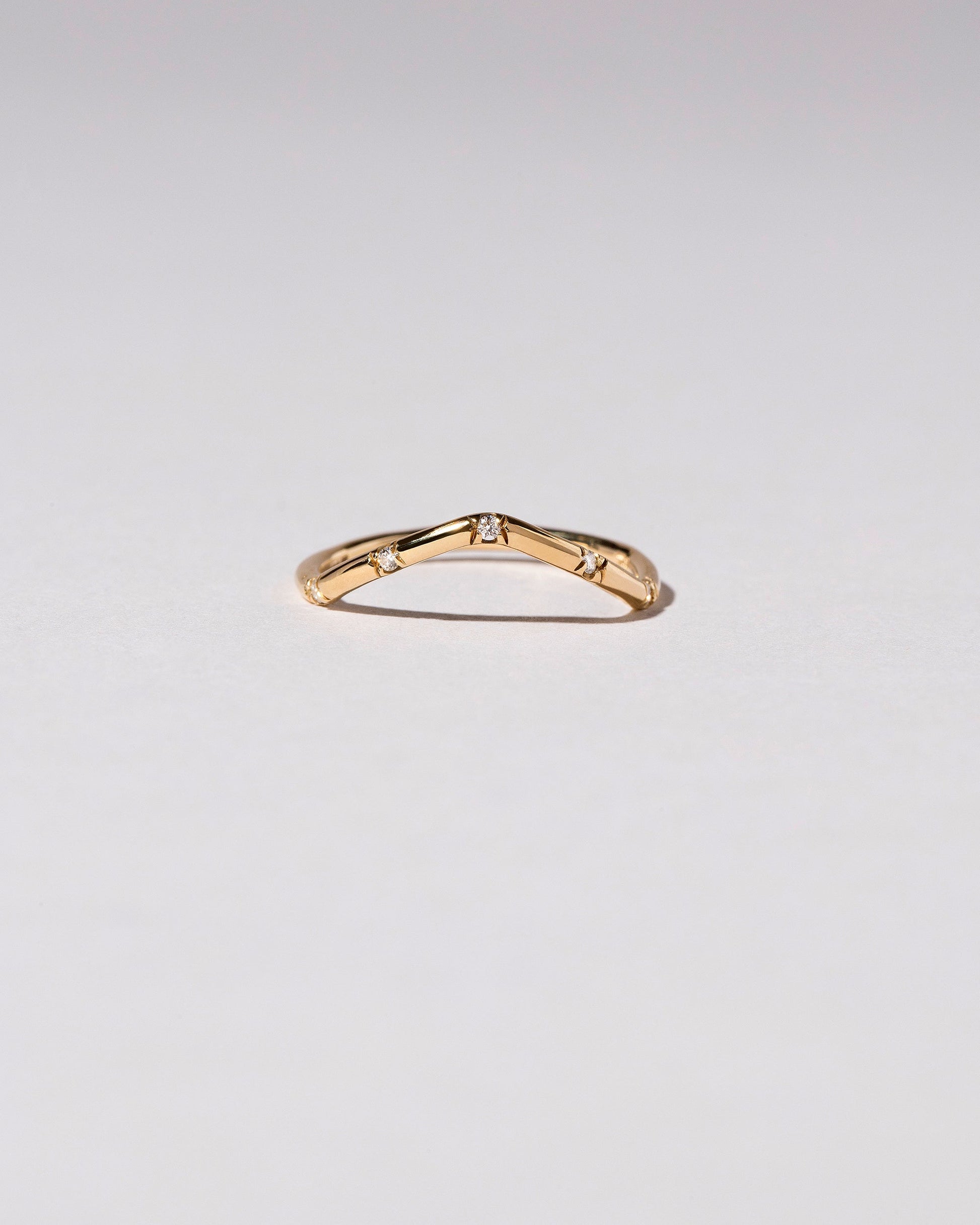 Gold White Diamond Five Stone Low Peak Band on light color background.