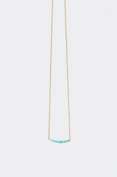 Turquoise Crescent Necklace on light color background.