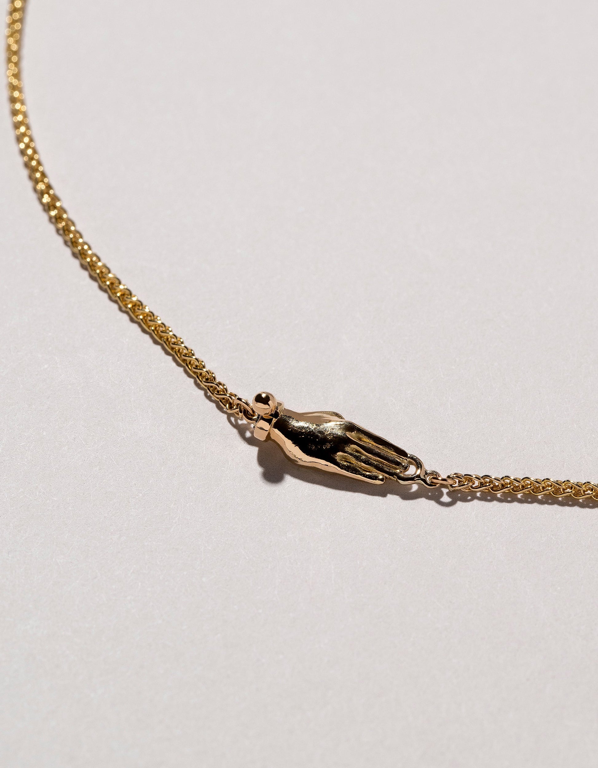 Manifestation Necklace on light color background.
