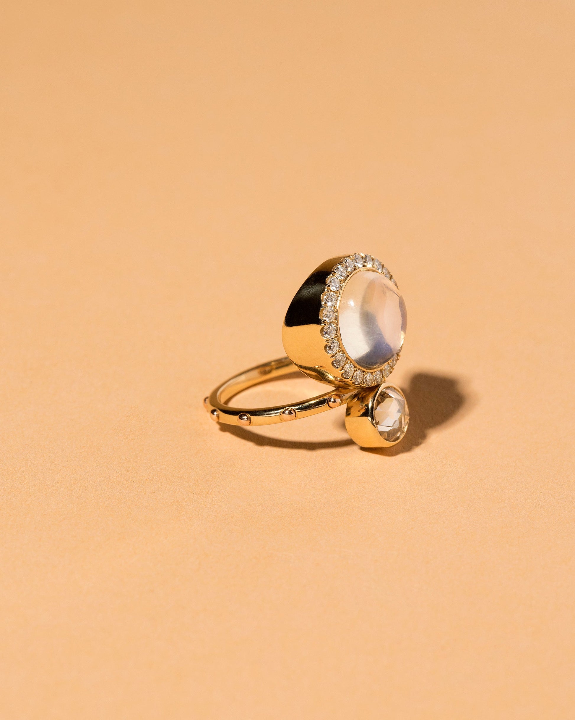  Moonstone & Diamond Cluster Ring on light color background.