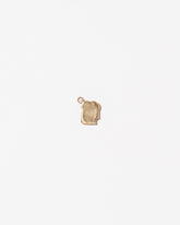 Bitten Toast Charm on light color background.