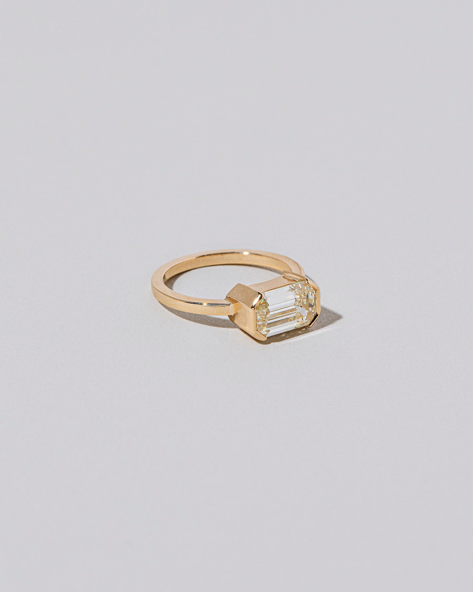 View from the side of the Two of Hearts Ring on light color background.