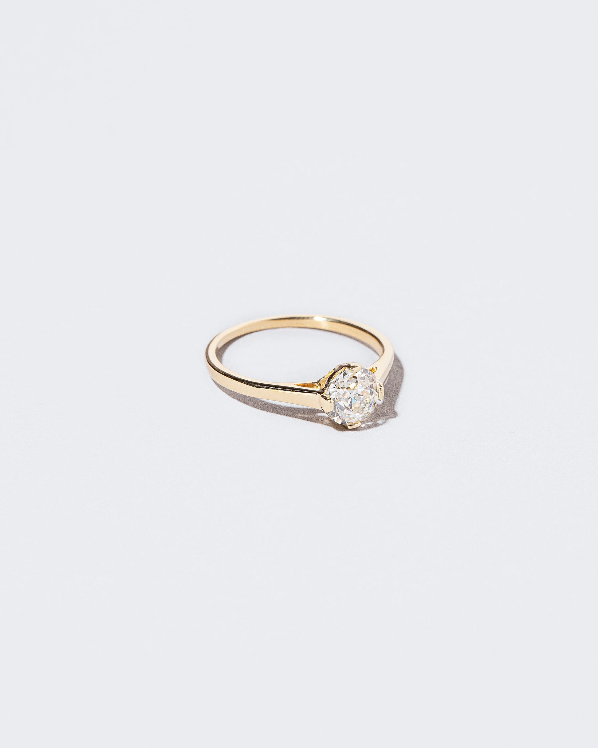 View from the side of the Grand White Diamond Barragán Ring on light color background.