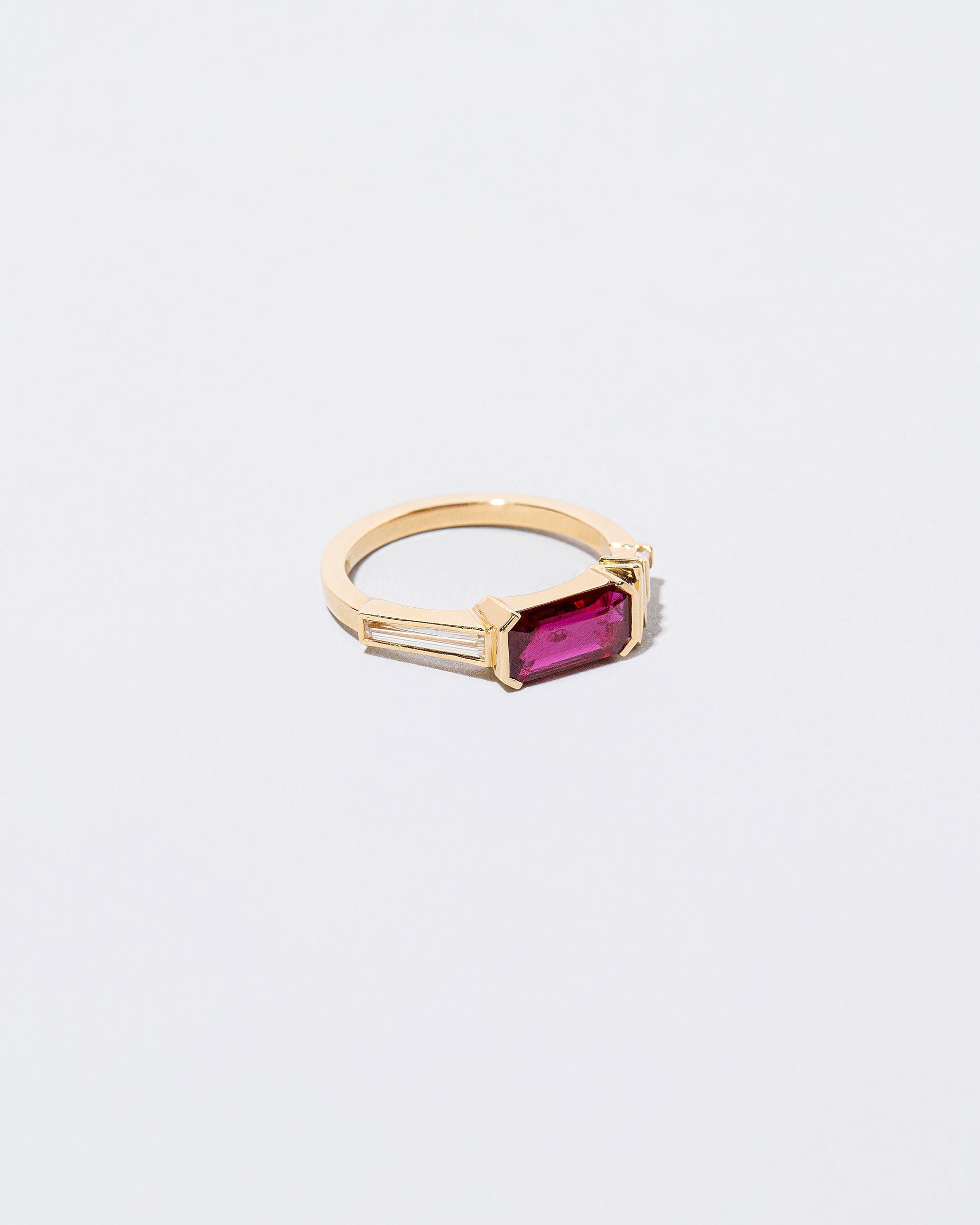 View from the side of the Femme Volage Ring on light color background.