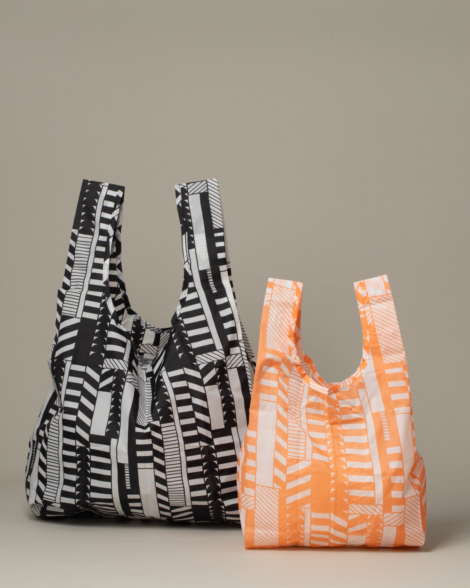 Group of Baby Peach and Standard Black Mociun Aerograph Print Baggus on light color background.