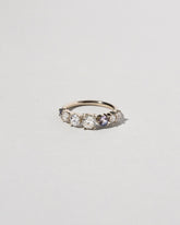 Diamond & Sapphire Line Cluster Ring on light color background.