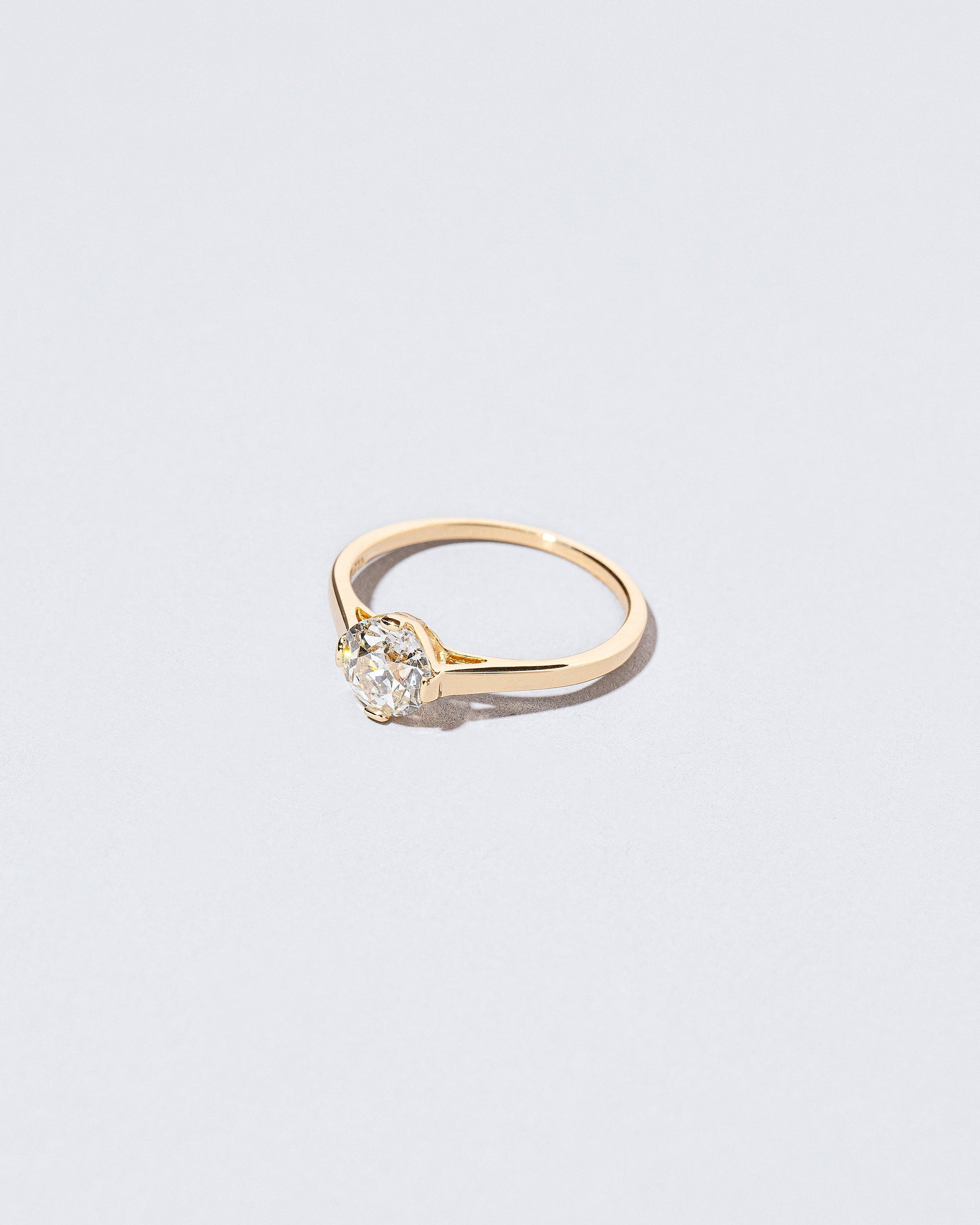 View from the side of the Grand White Diamond Barragán Ring on light color background.