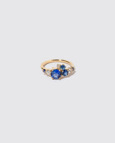 Limited-edition blue sapphire and white diamond Luna Ring on light color background.