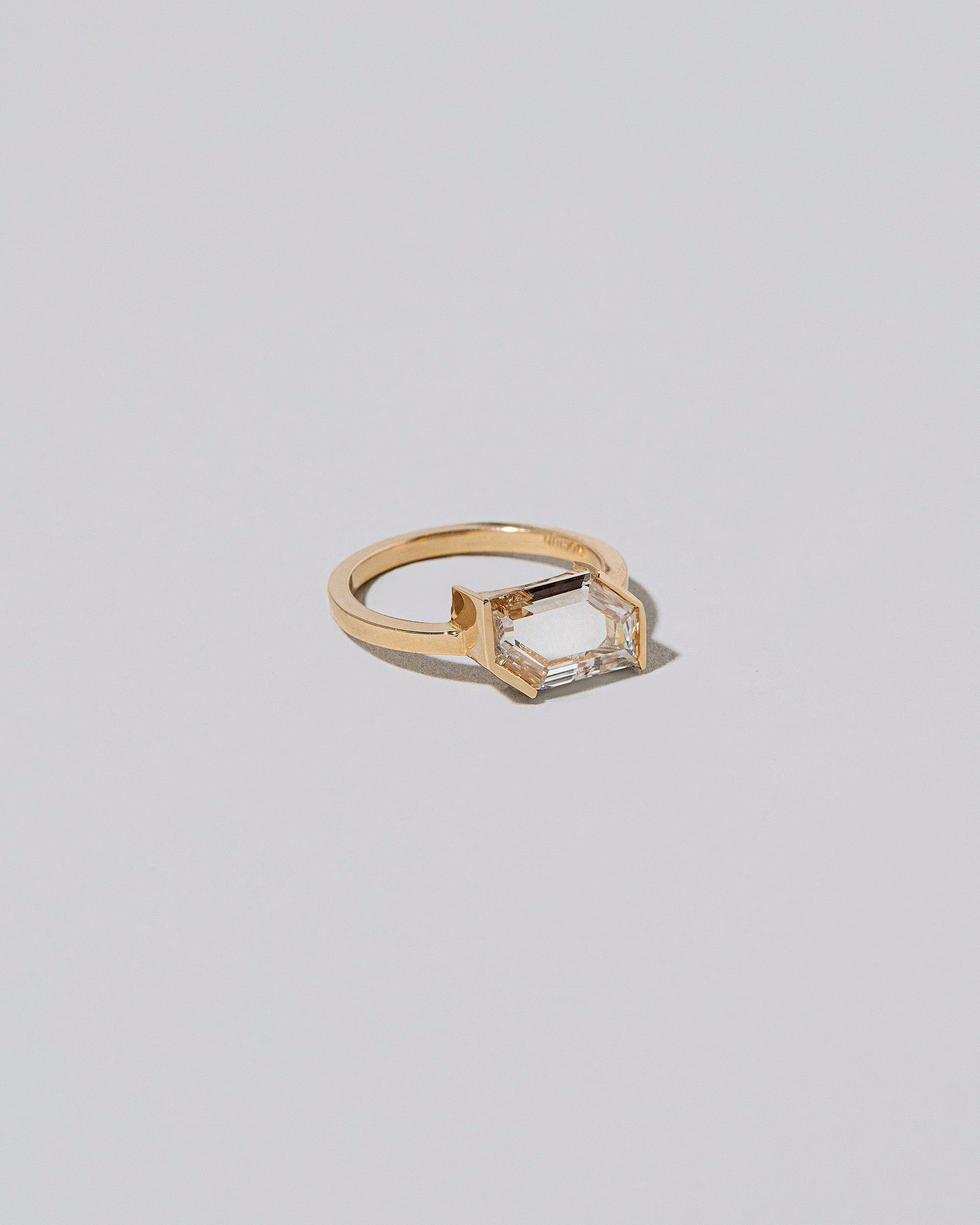 View from the side of the Heart & Soul Ring on light color background.