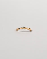 Gold Three Stone Blue Sapphire Low Peak Band on light color background.