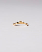 Gold Single Stone Blue Sapphire Low Peak Band on light color background.