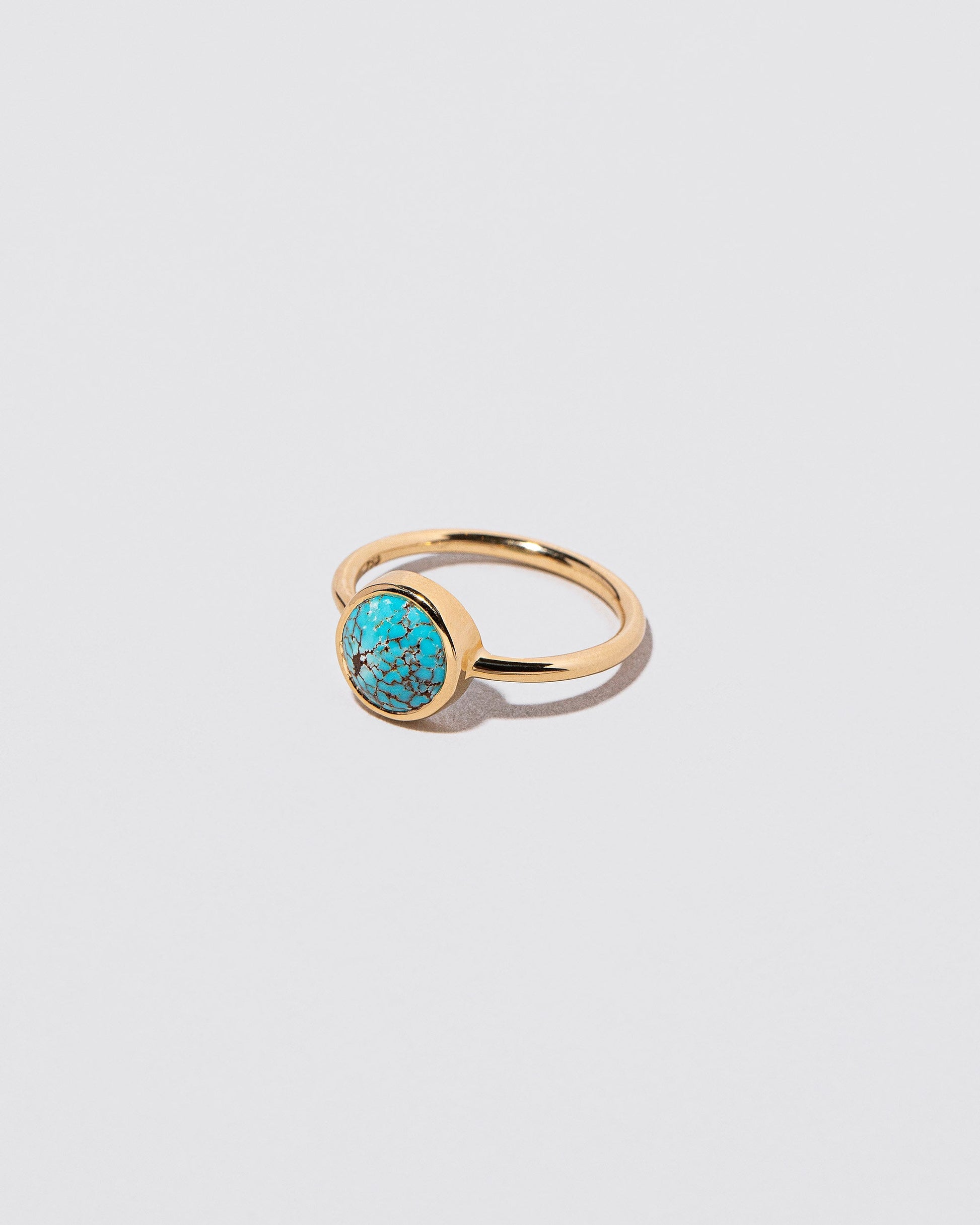 View from the side of the Wisdom Ring on light color background.