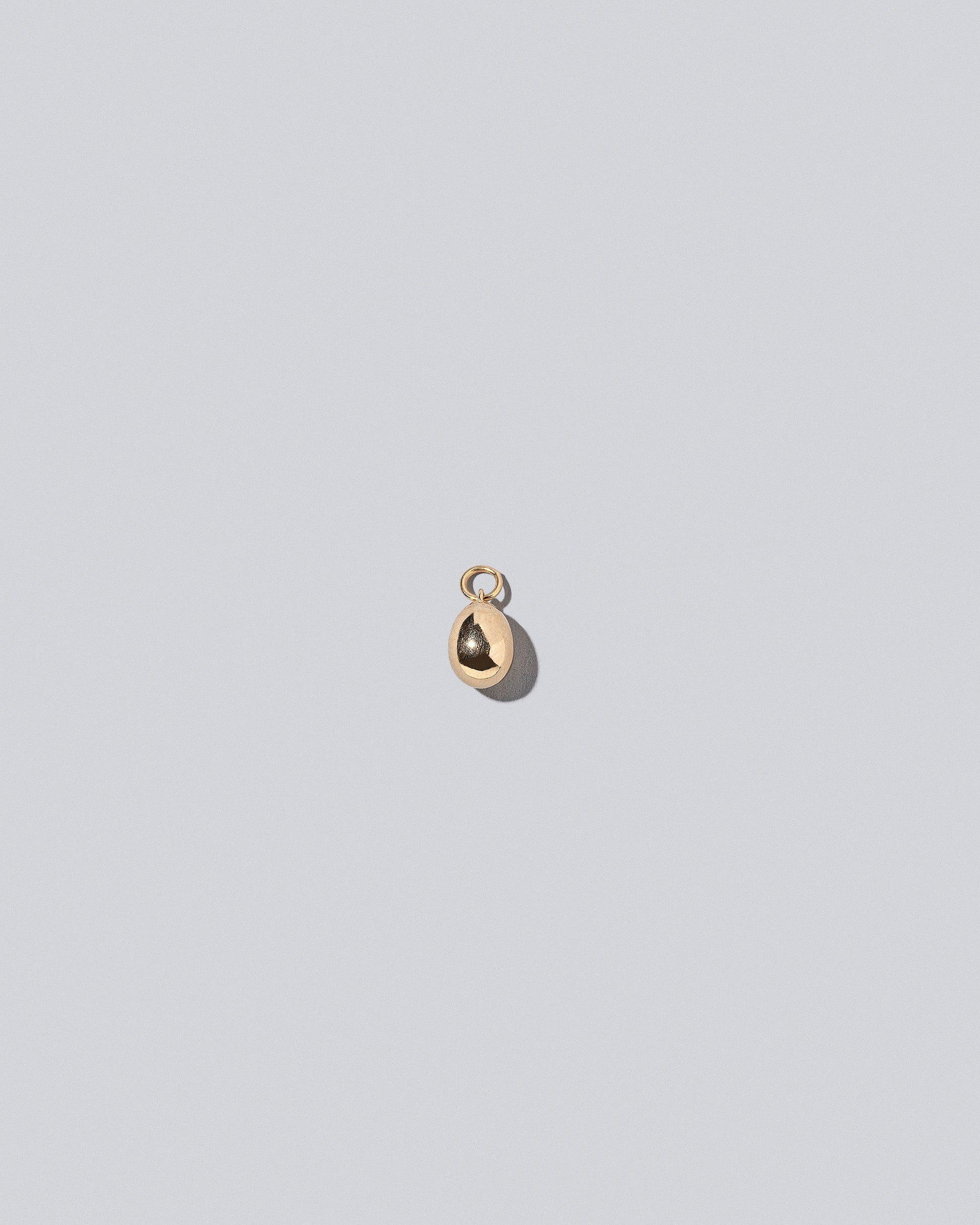 Egg Charm on light color background.