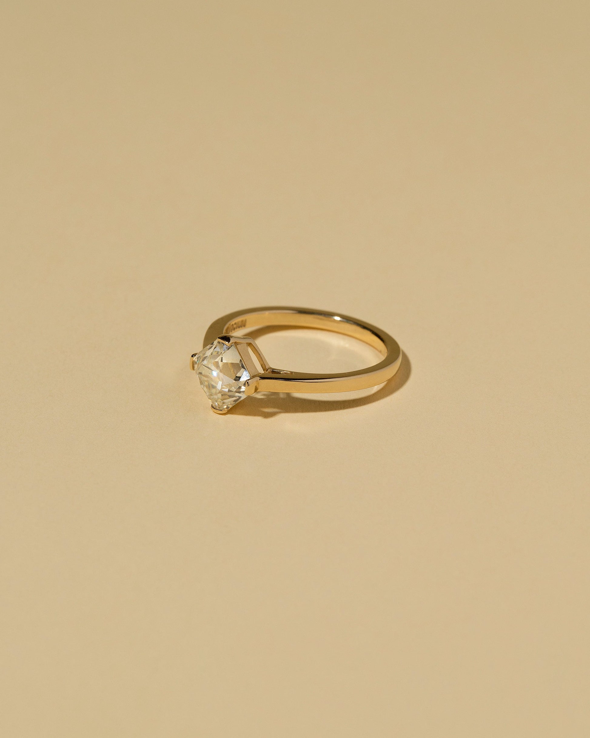 View from the side of the Cushion Modified Brilliant Diamond Solitaire Ring on light color background.