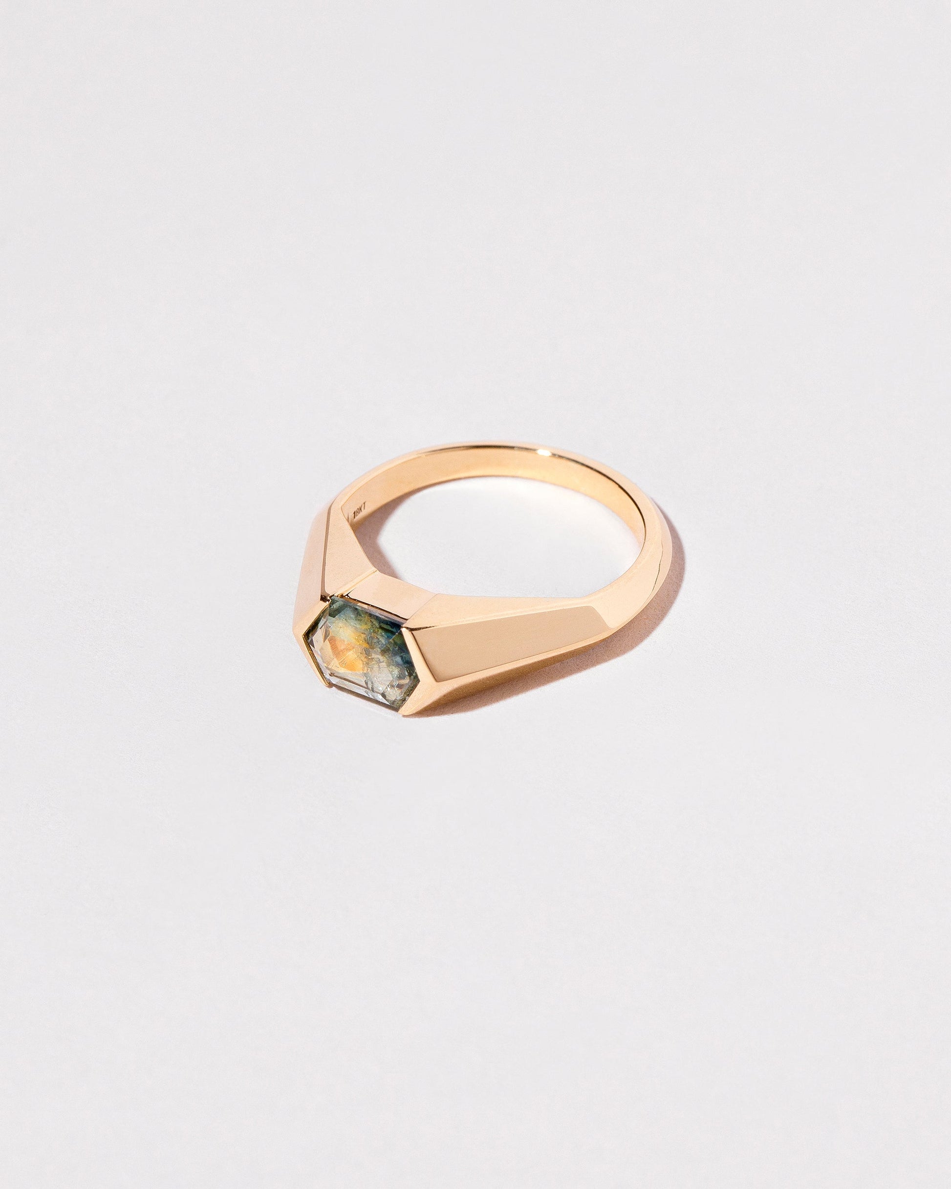 View from the side of the Caelum Ring on light color background.