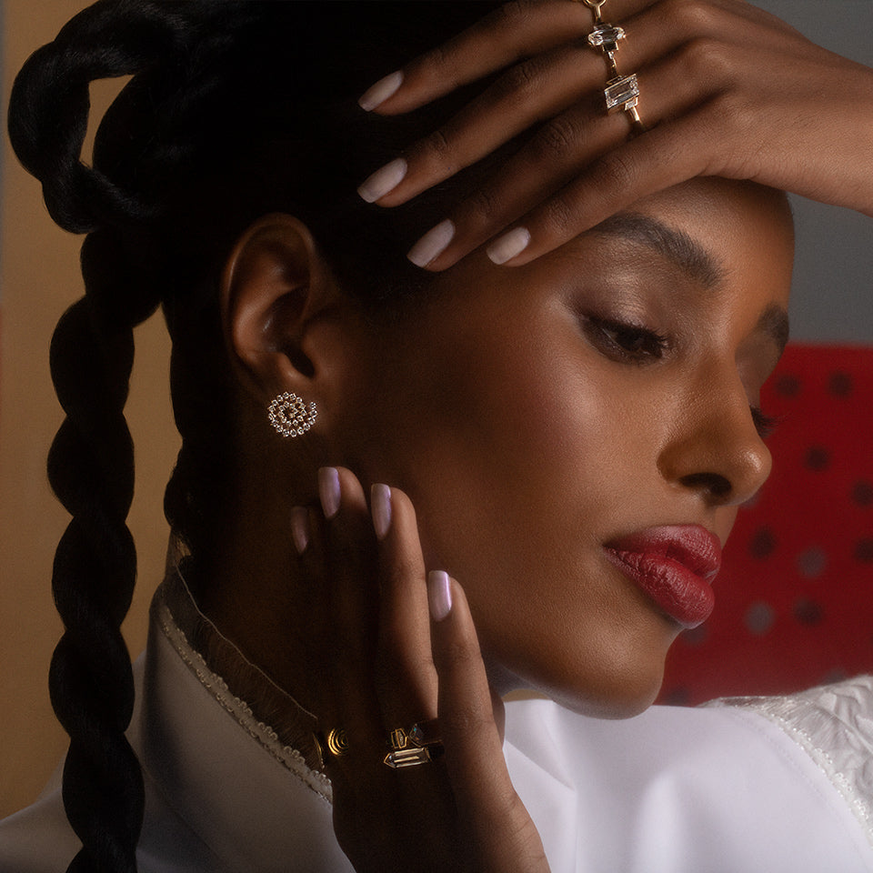 product_details::Full White Diamond Left Spiral Stud Earring Single on model.