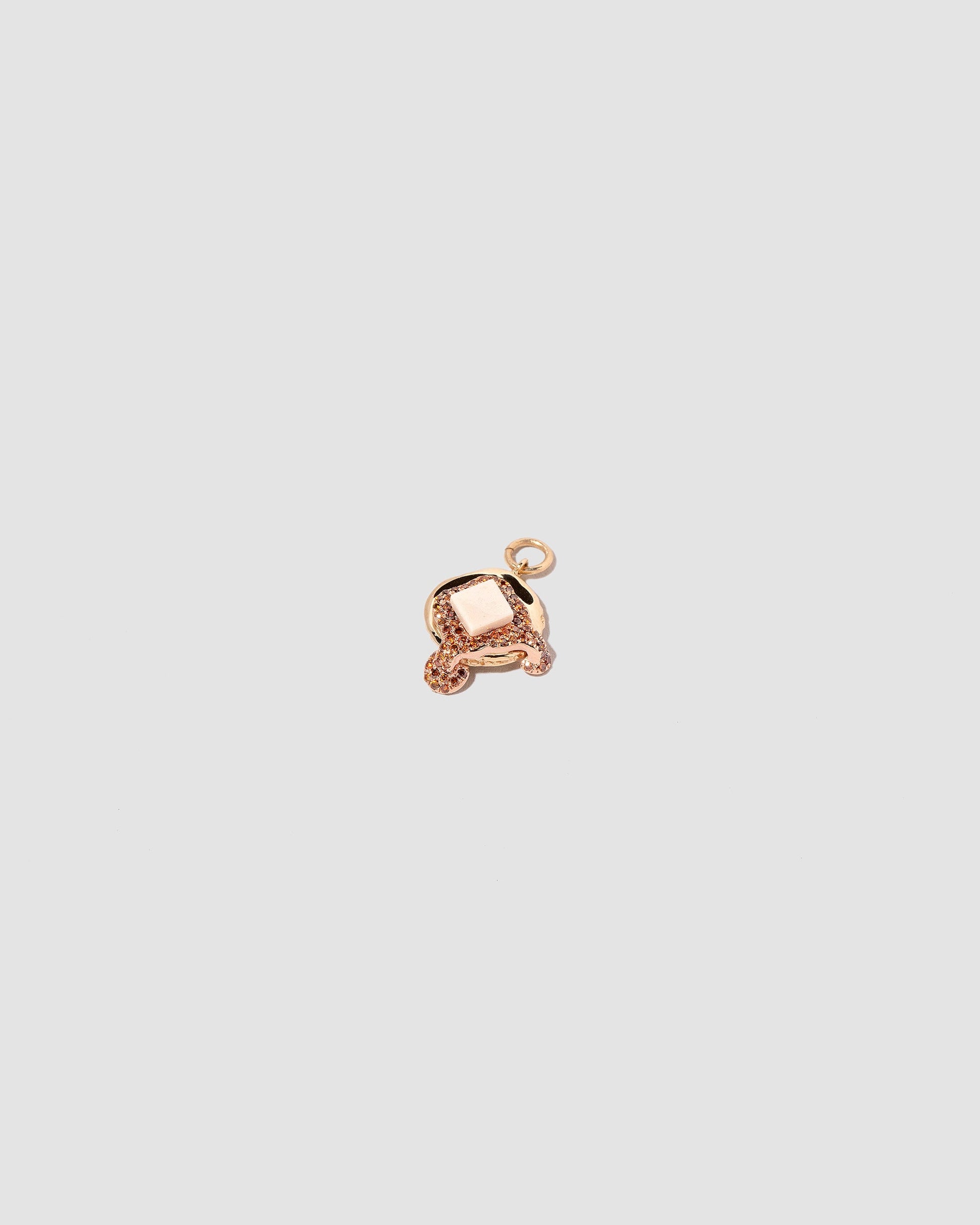 View from the side of the Flapjack Pancake Charm on light color background.