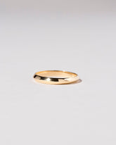 Gold 3mm Knife Edge Band on light color background.