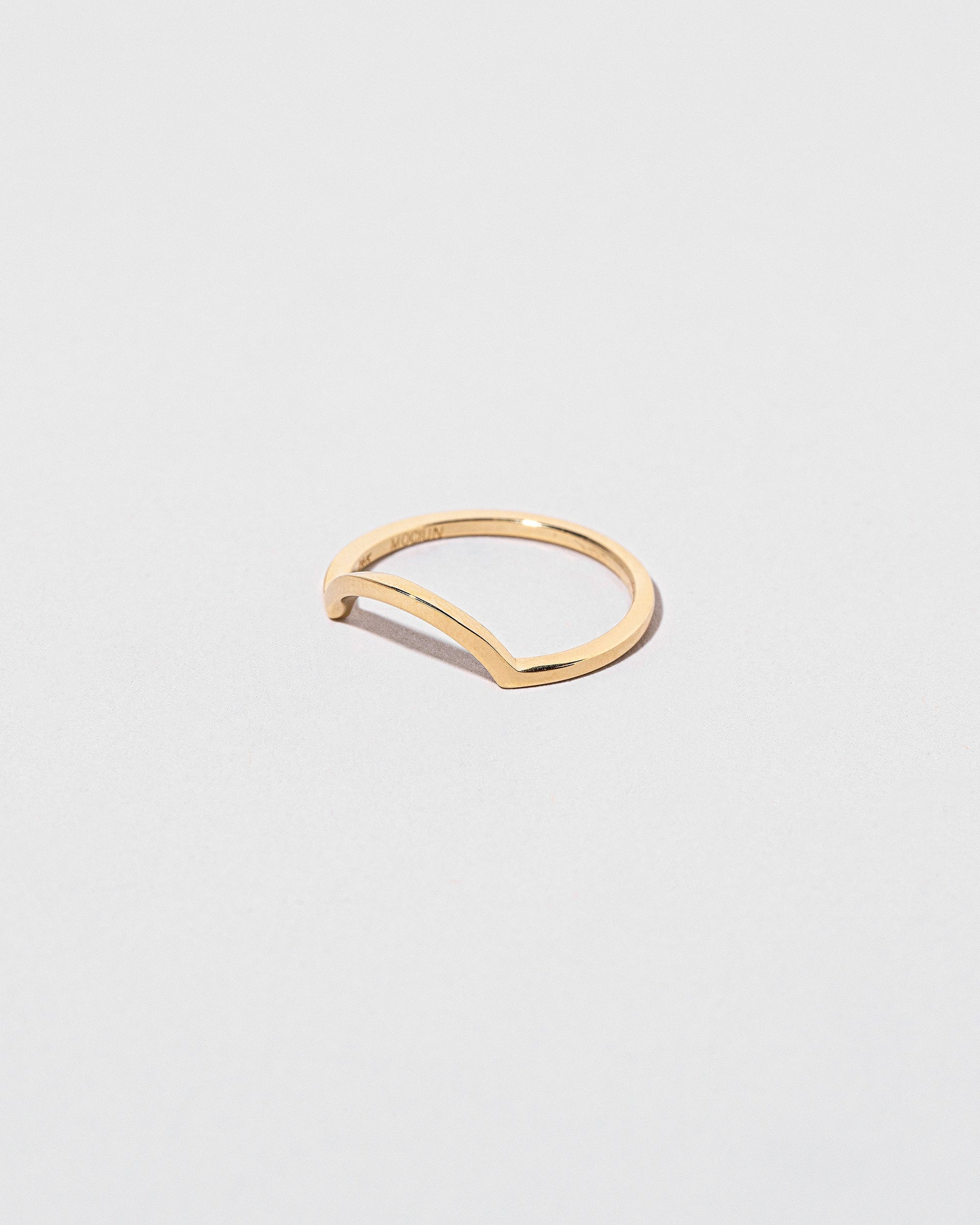 View from the side of the Gold Square Wire Curve Band on light color background.