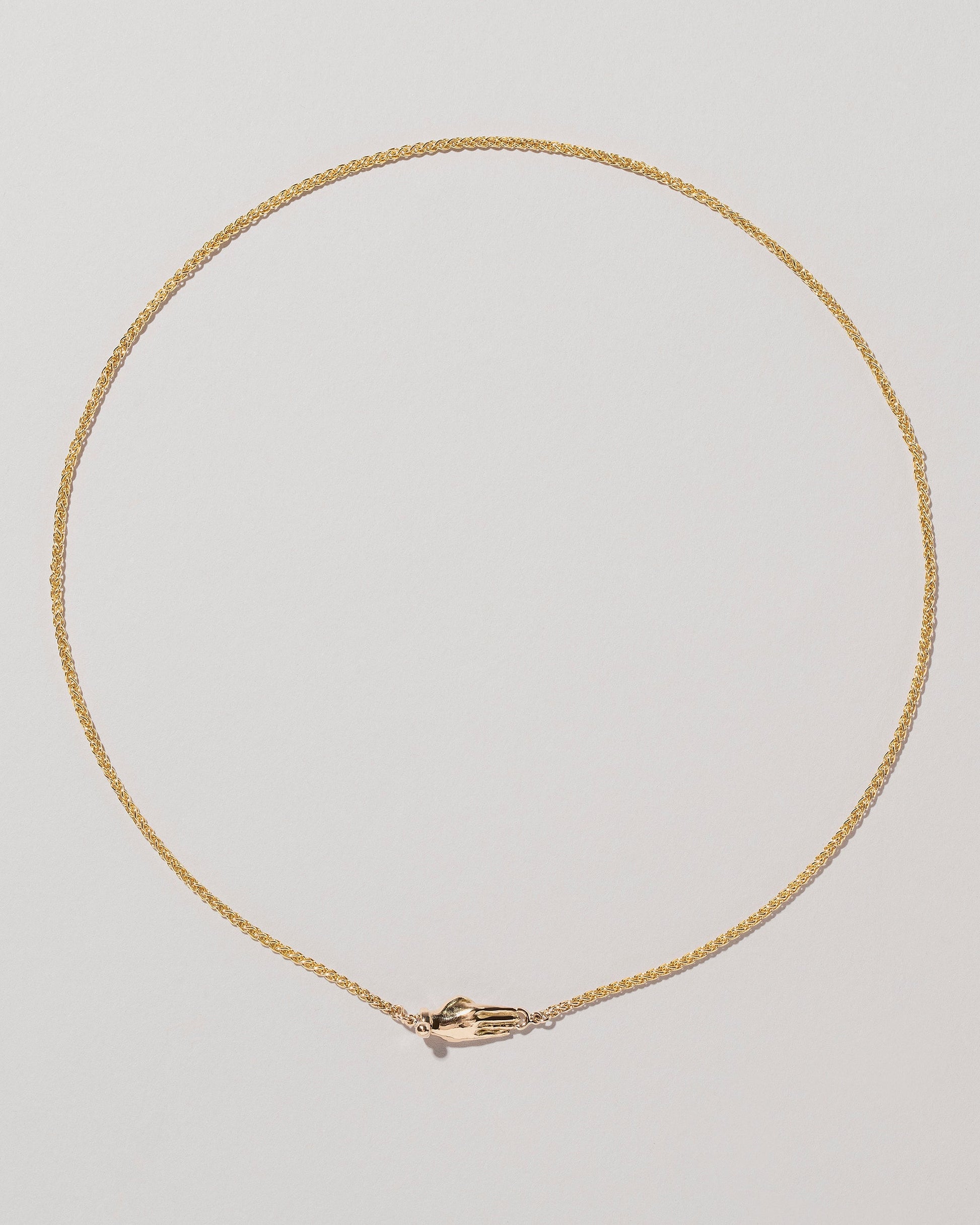 Manifestation Necklace on light color background.