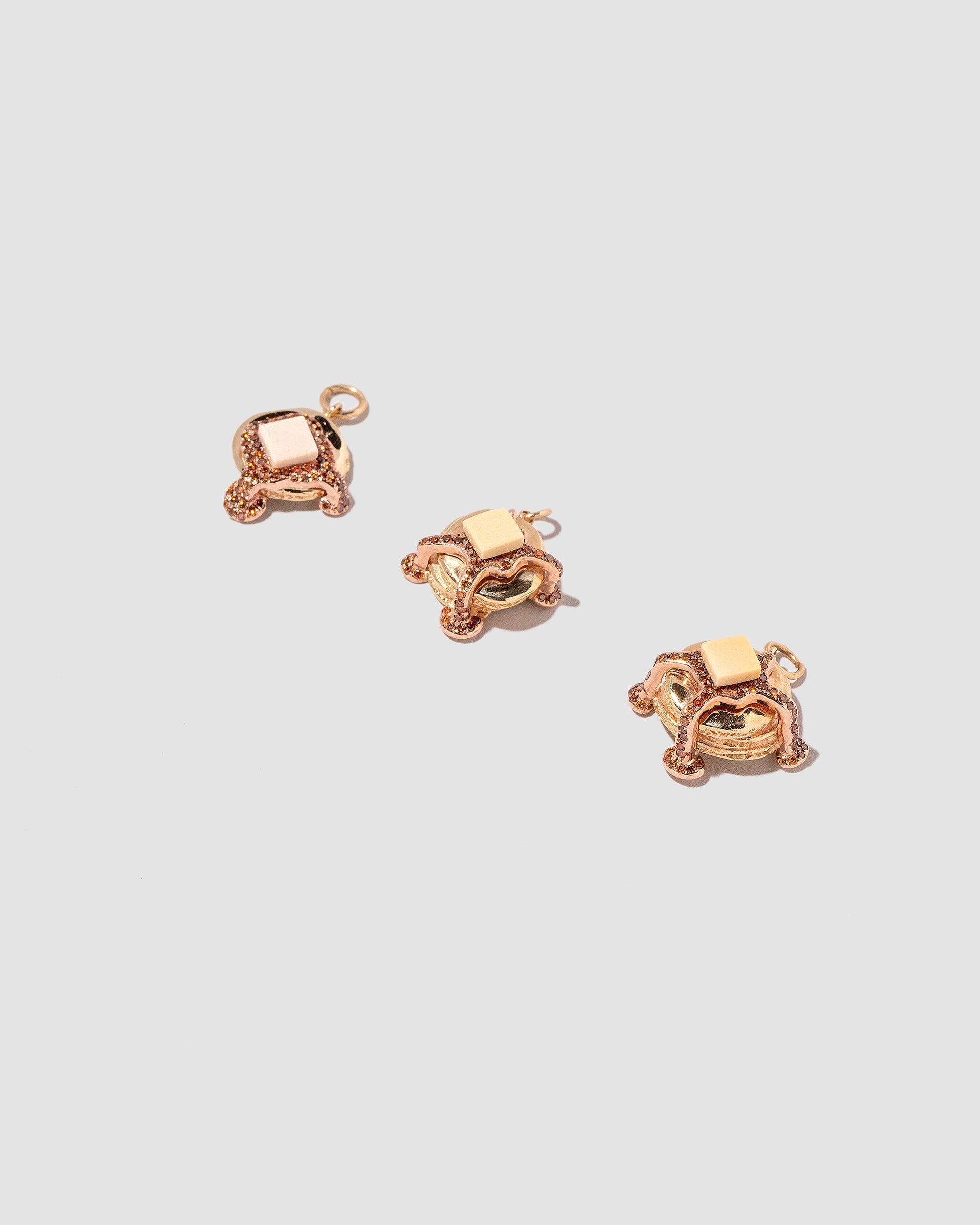 Closeup details of the Flapjack Pancake Charm, Short Stack Pancake Charm and Tall Stack Pancake Charm on light color background.