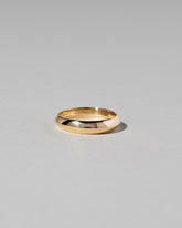 Gold 4mm Knife Edge Band on light color background.