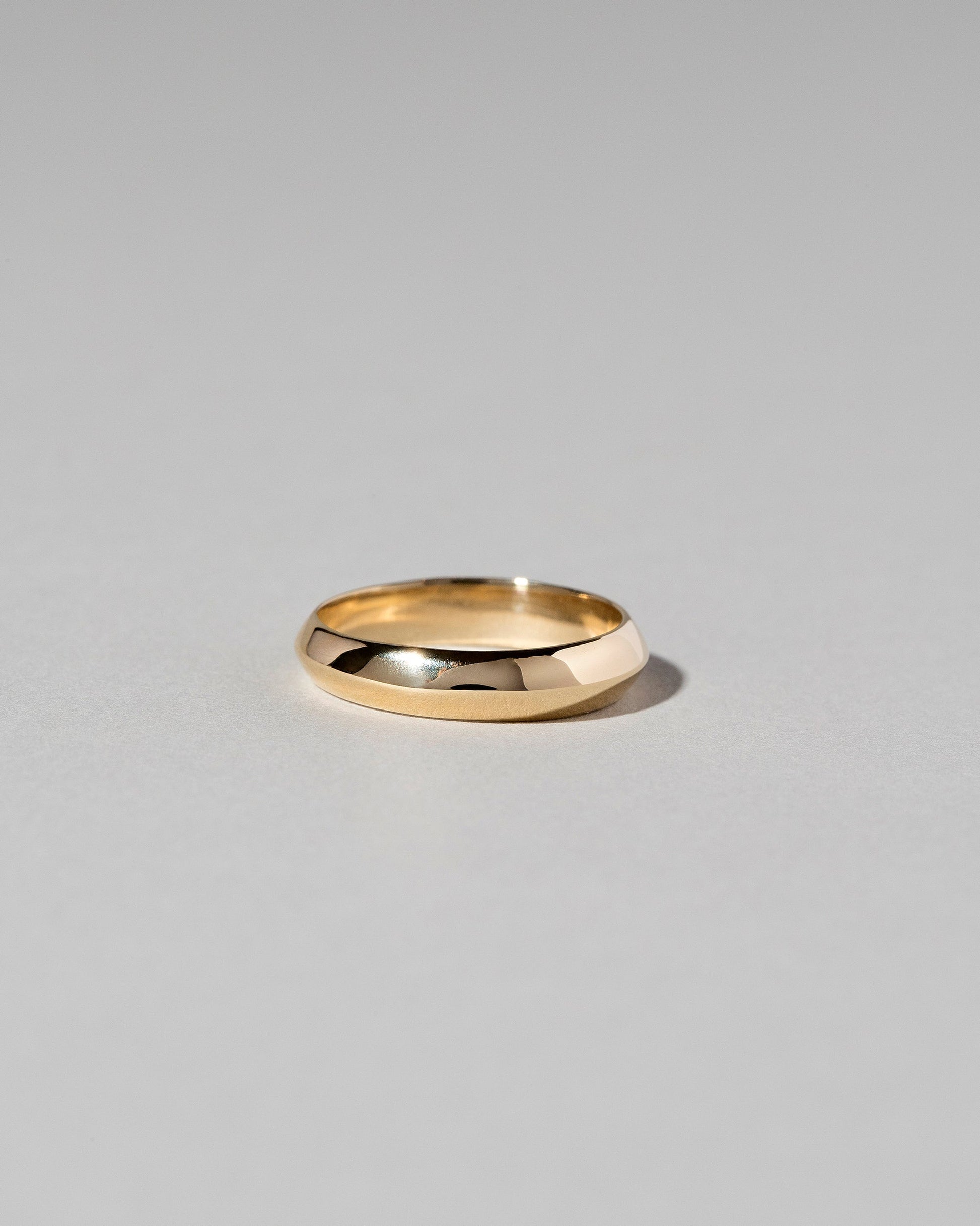 Gold 4mm Knife Edge Band on light color background.