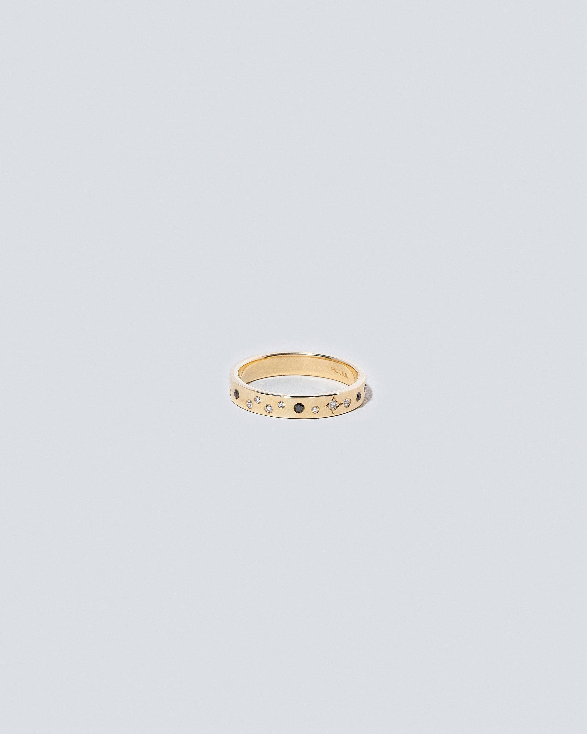 Gold 3mm Square Wire Band with Big Array Black & White Diamonds added on light color background.