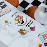 product_details::Styled image featuring the Jelly Toast Charm, Sausage Links Charm and Sunny Side Up Egg Charm.