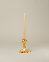 POLSPOTTEN Gold Small Drip Candle Holder on light color background.