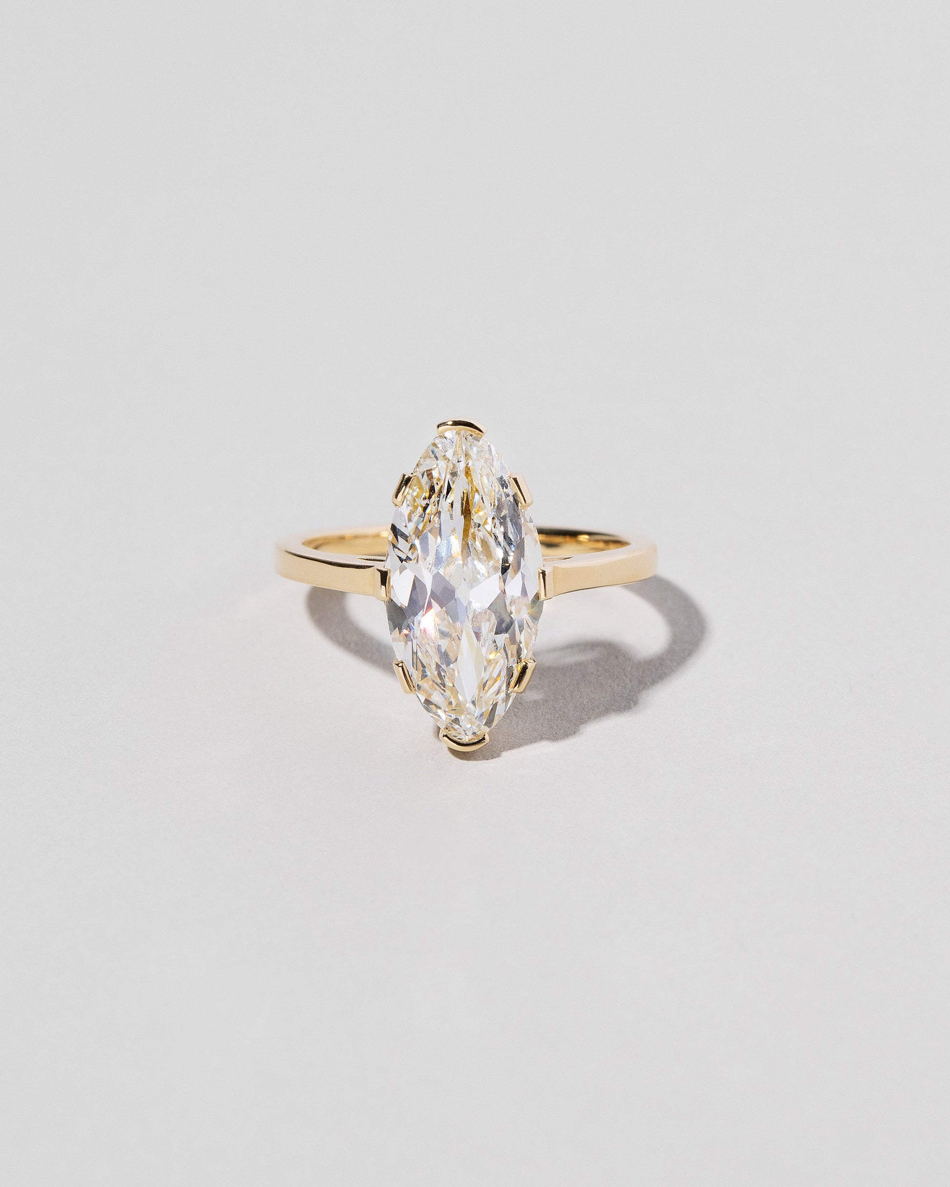 North-South Navette Diamond Solitaire Ring on light color background.