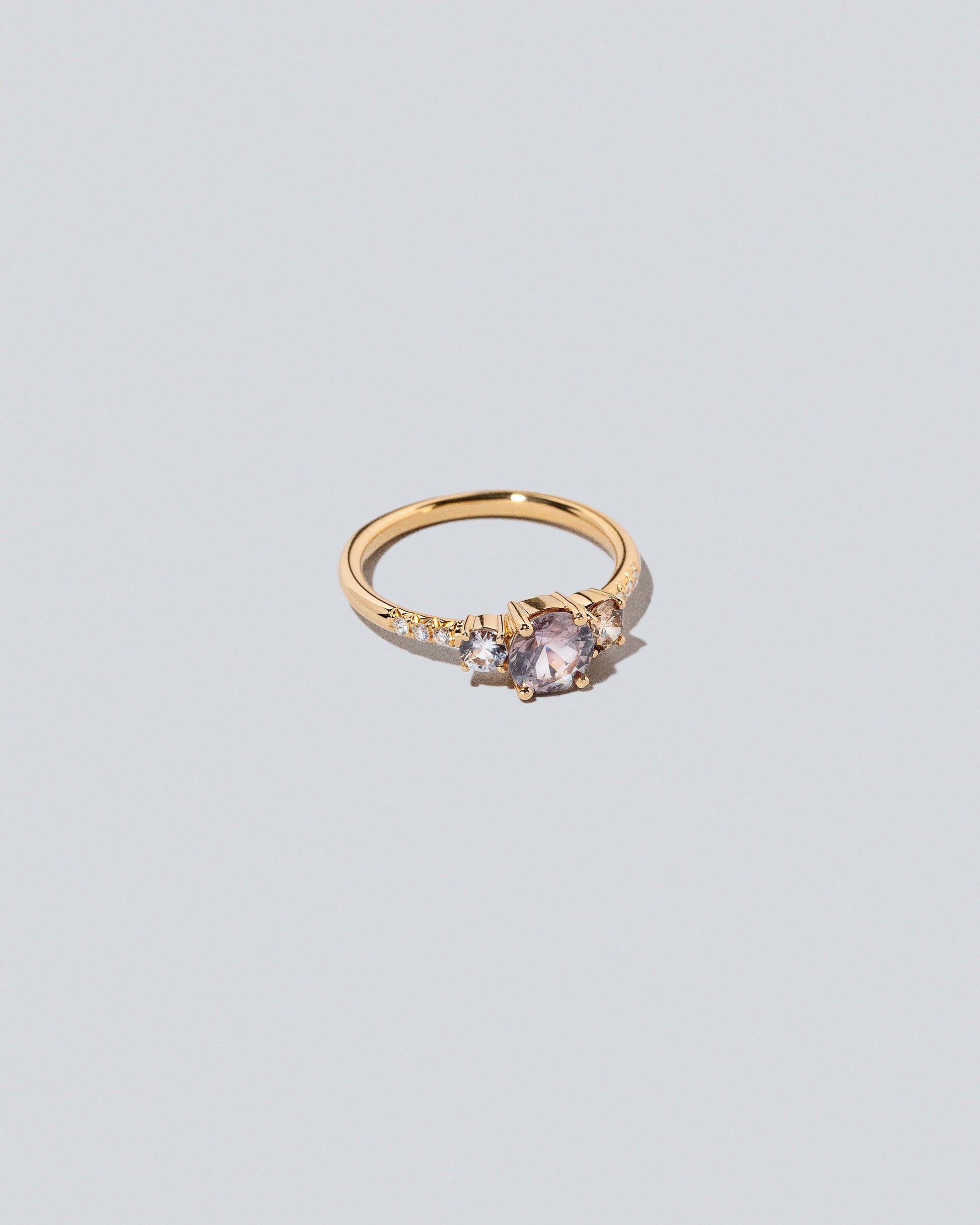 View from the side of the Purple Sapphire & Champagne Diamond Orion Ring on light color background.