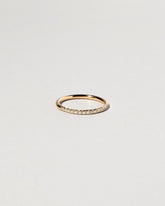 Gold White Diamond Sapphire Fifteen Stone Dot Band on light color background.