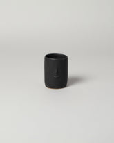  Rami Kim Black Mini Face Tumbler on light color background.
