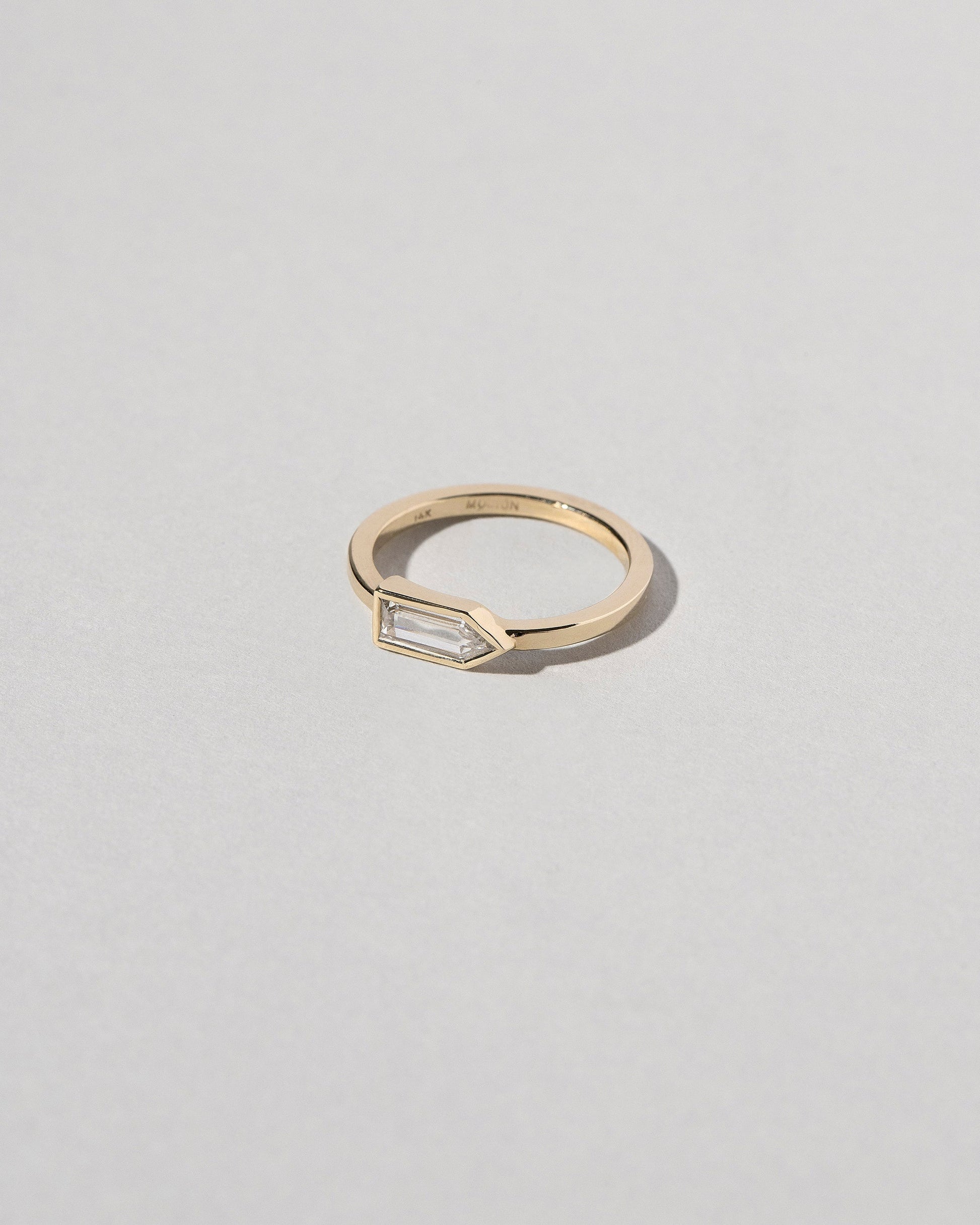 View from the side of the Bullet Cut Diamond Ring on light color background.