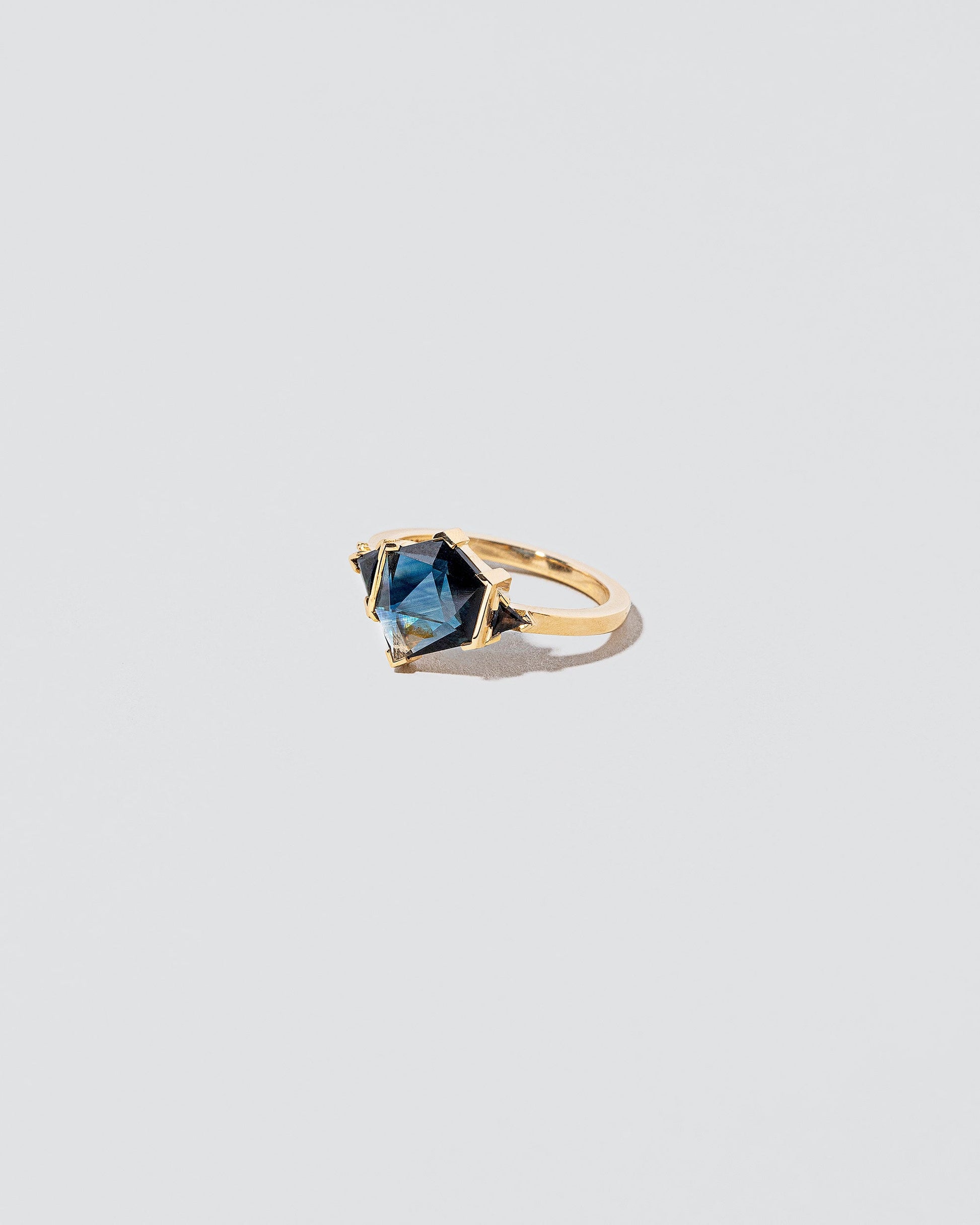 View from the side of the Side by Side Ring on light color background.